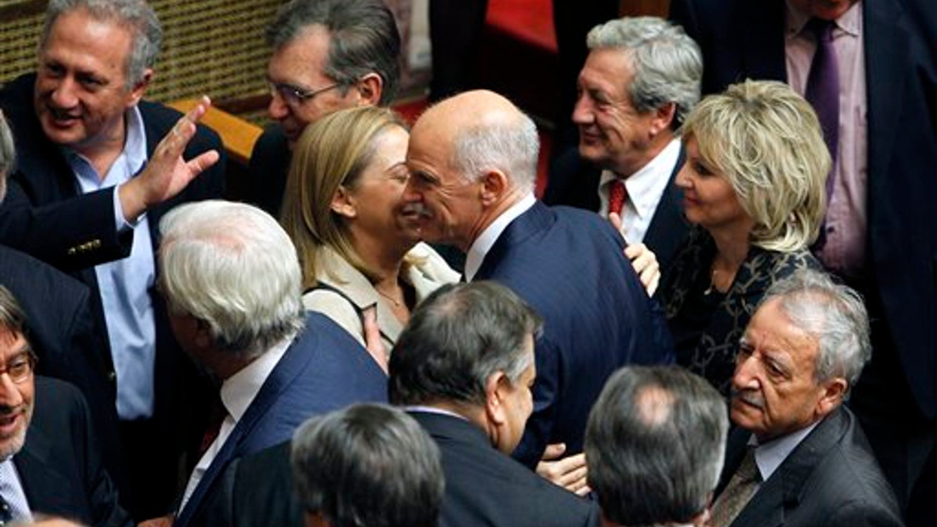 Nov. 5, 2011: Greek Prime Minister George Papandreou, center, is congratulated by his party's ministers and lawmakers after surviving a confidence vote.