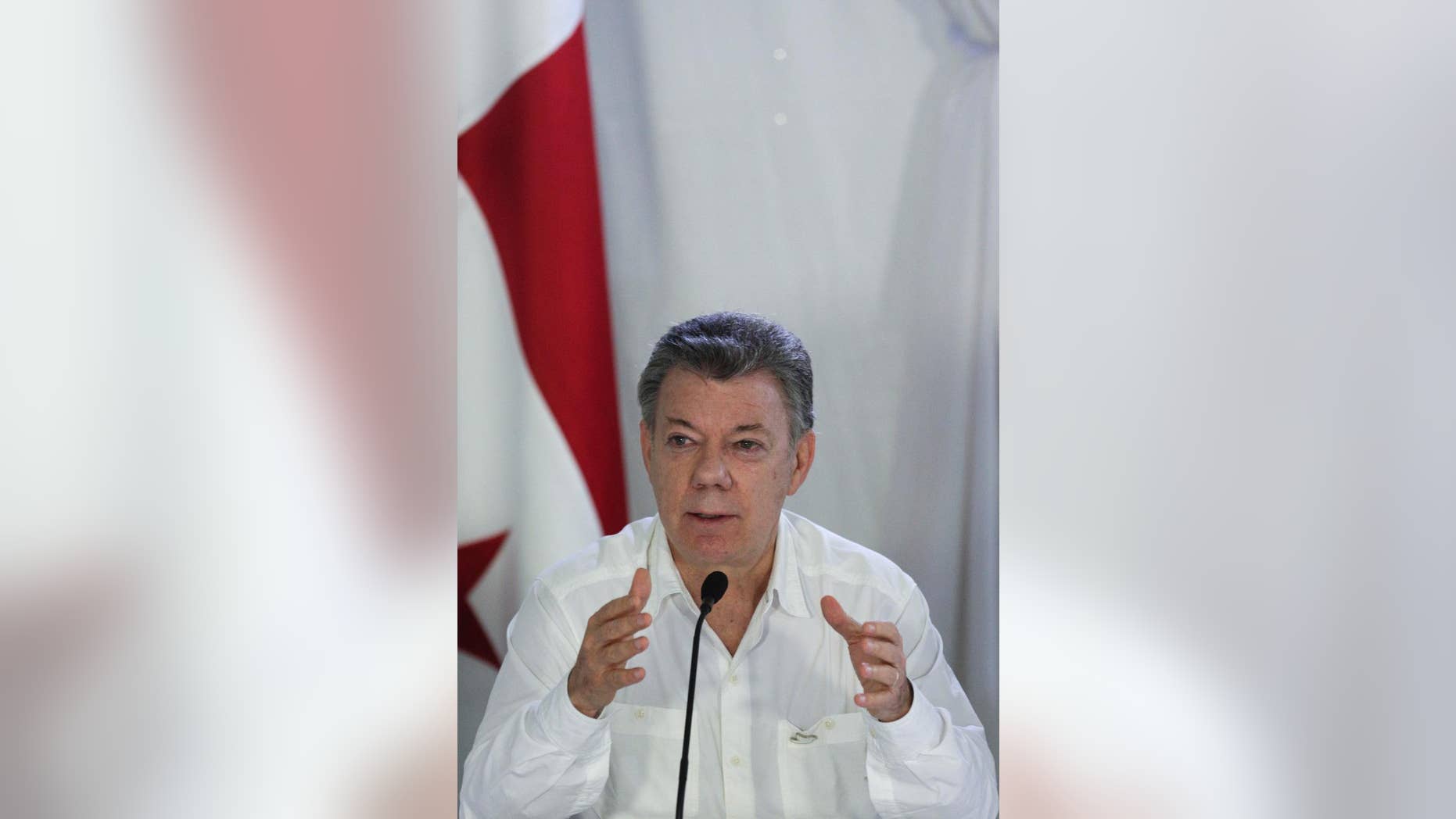 Colombia's President Juan Manuel Santos speaks during a press conference after a meeting with his Panamanian counterpart Juan Carlos Varela at the Nicanor Air Naval base in Darien province, Panama, Tuesday, Oct. 25, 2016. Santos and Varela discussed security and immigration issues between both countries. (AP Photo/Arnulfo Franco)