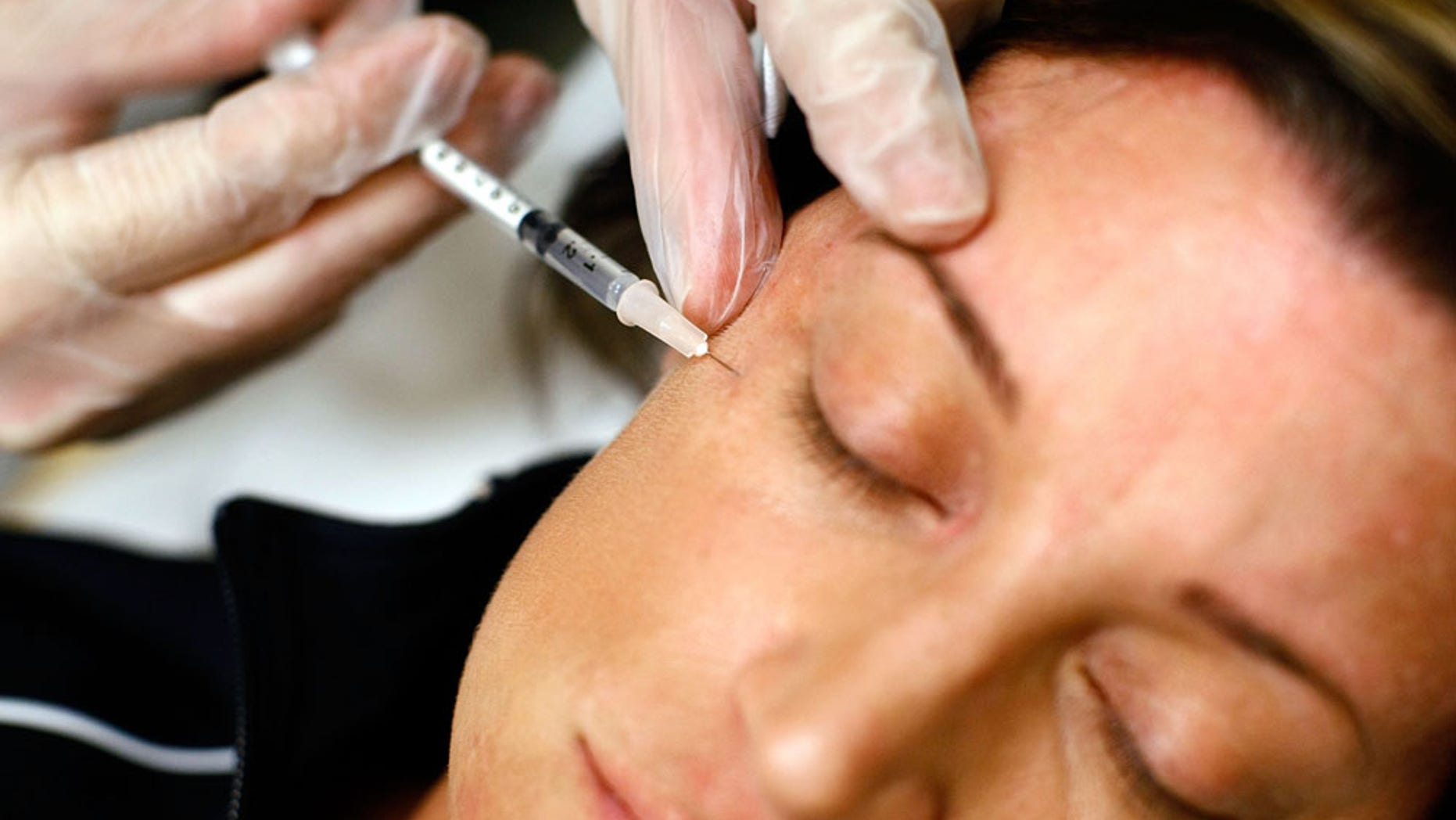ARLINGTON, VA - JUNE 05: Recently laid off worker Lyn Talent receives a free Botox injection during an event called the "The Botox Bailout" where the first 50 recently laid-off workers could exchange their resumes for free Botox injections June 5, 2009 in Arlington, Virginia. The event, which took place in a Reveal store, also featured recruiters to help job seekers network, collect resumes and offer on-site interviews. (Photo by Win McNamee/Getty Images)