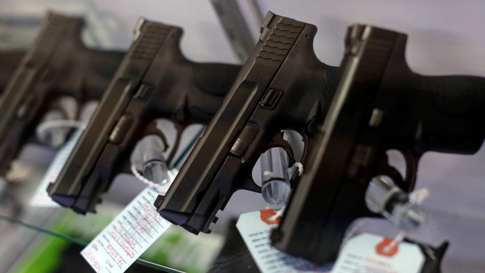 FILE -- Handguns are seen for sale in a display case.