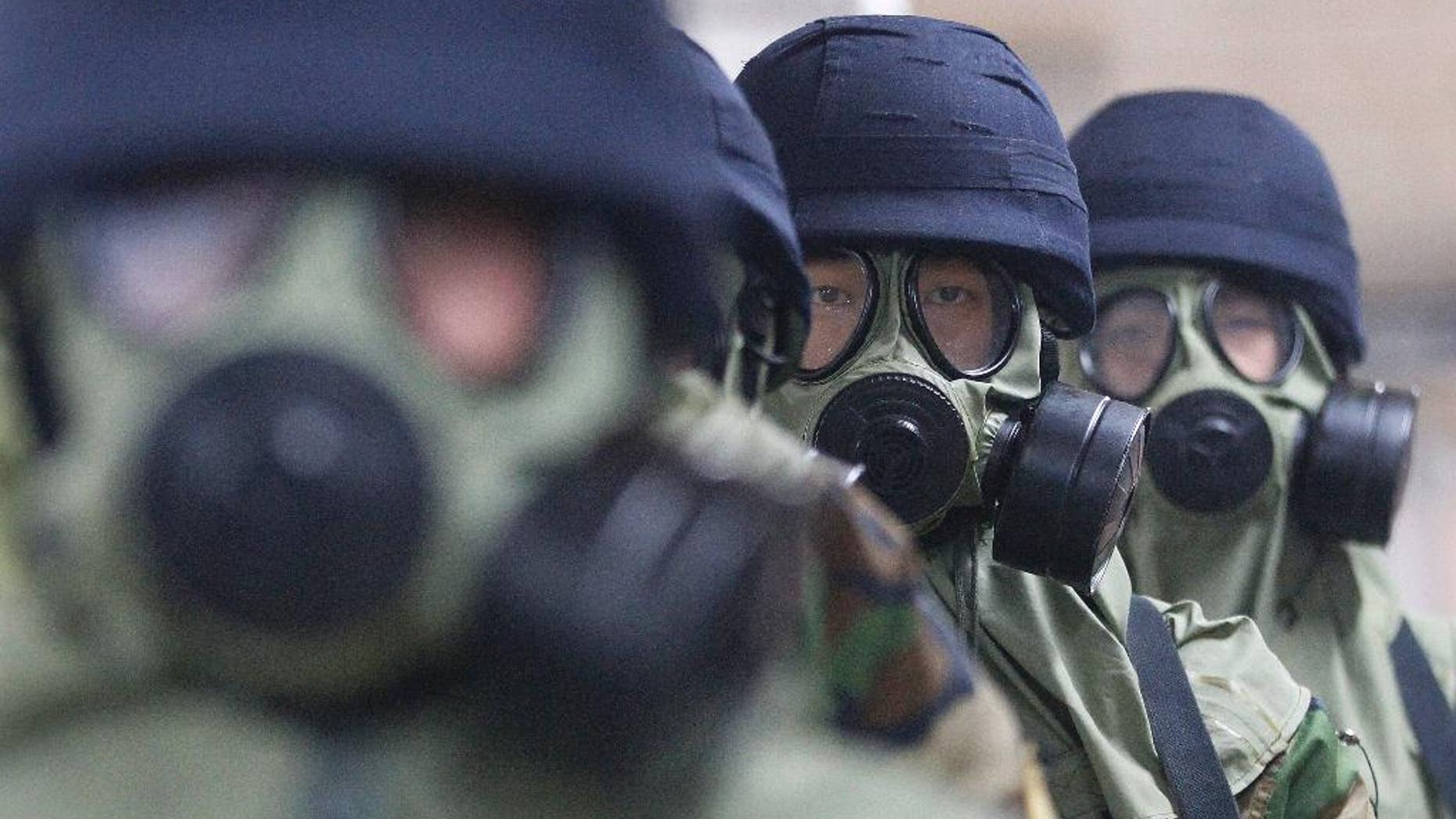 South Korean police officers wearing gas masks conduct an anti-terror drill as part of Ulchi Freedom Guardian exercise, at Yoido Subway Station in Seoul, South Korea, Tuesday. South Korea and the United States began annual military drills Monday despite North Korea's threat of nuclear strikes in response to the exercises that it calls an invasion rehearsal.