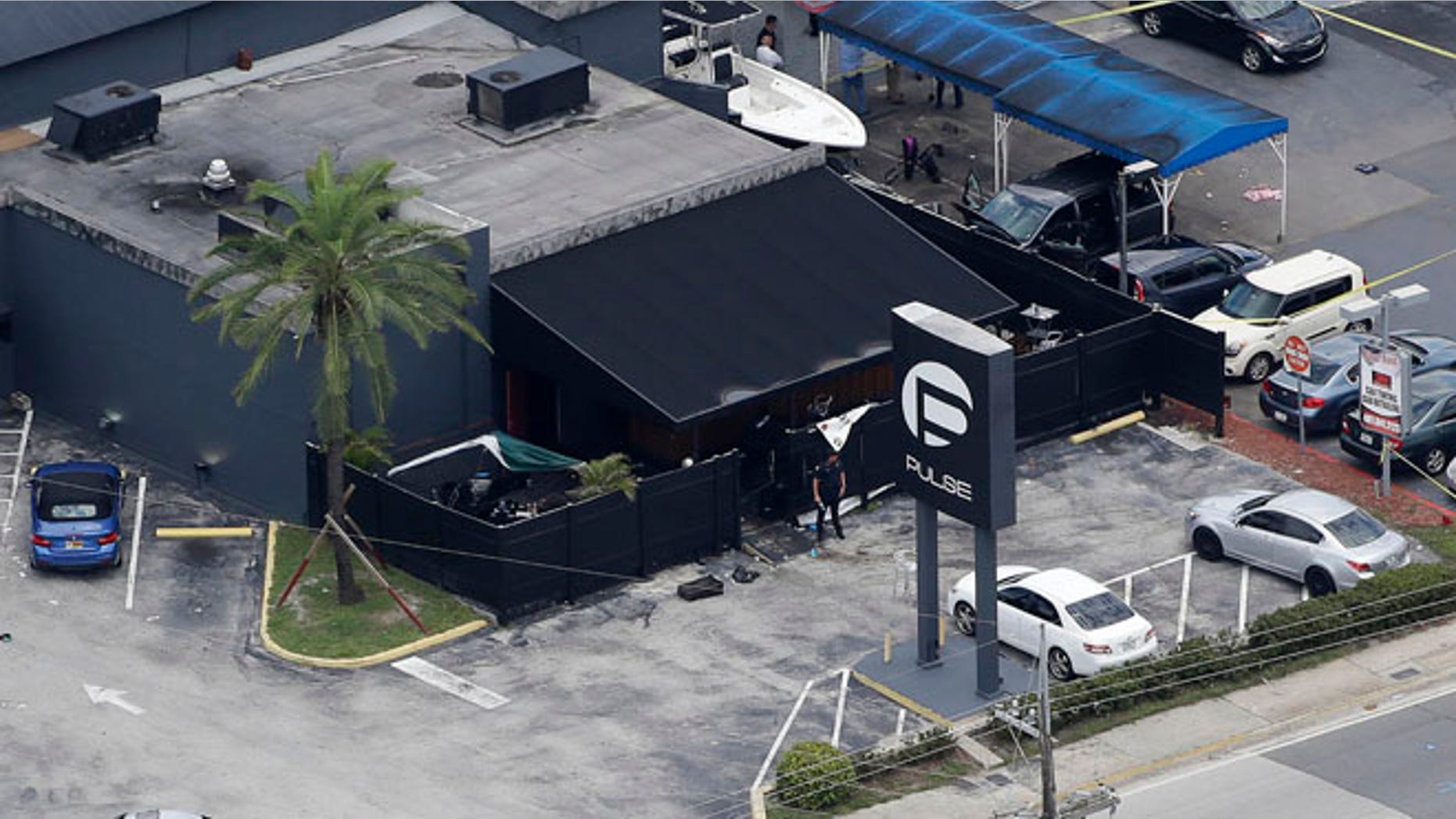 Law enforcement officials work at the Pulse gay nightclub in Orlando, Fla.