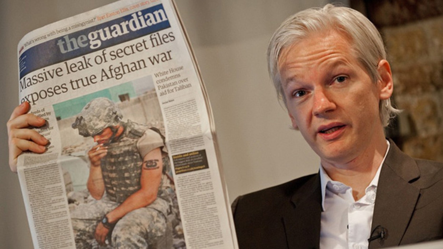 July 26: WikiLeaks founder Julian Assange holds up a copy of Britain's Guardian newspaper during a press conference in London.