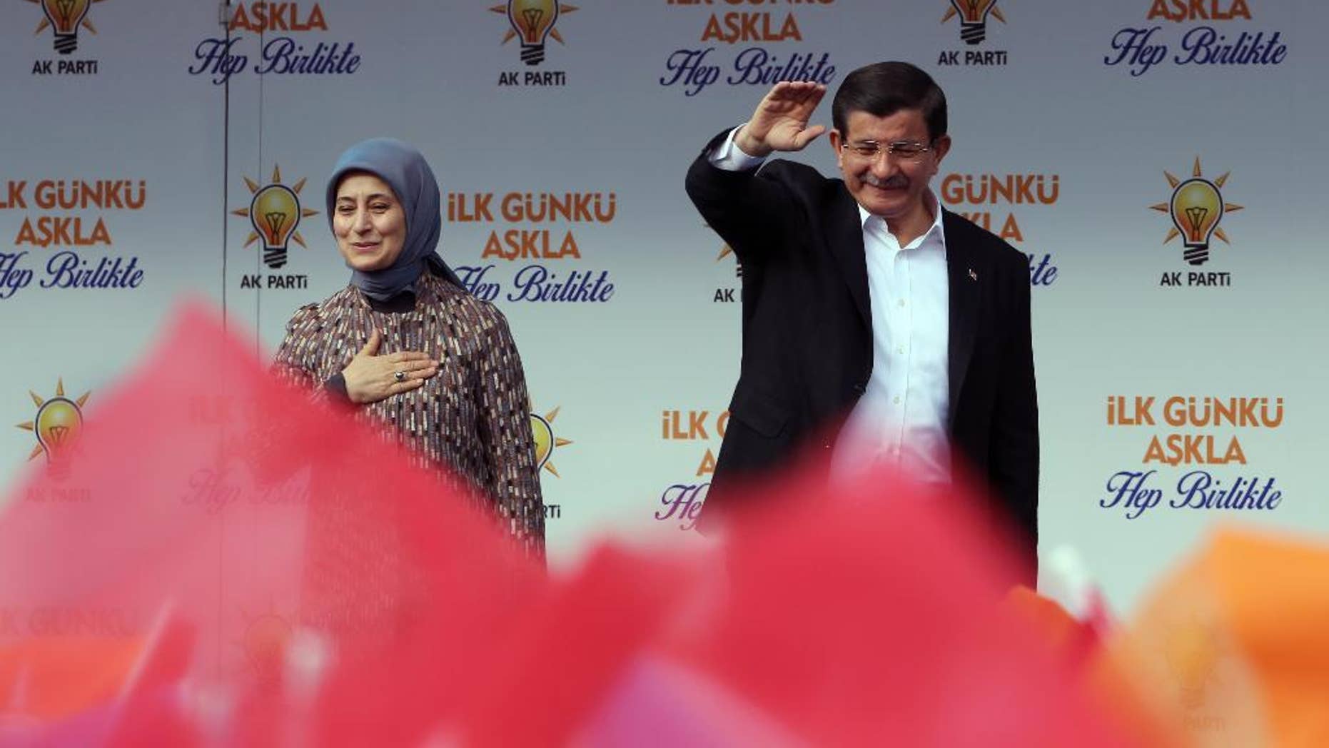 Turkish Prime Minister Ahmet Davutoglu and his wife Sare Davutoglu salute cheering supporters during a rally in Ankara, Turkey, Saturday, Oct. 31, 2015.
(AP Photo/Burhan Ozbilici)