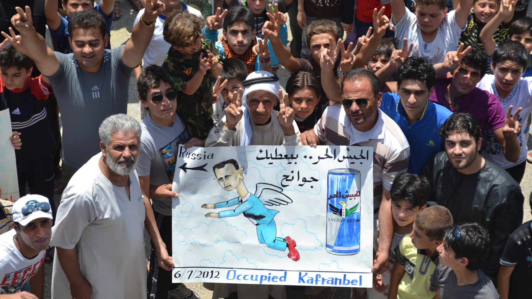 July 6, 2012: This citizen journalism image released by Shaam News Network taken purports to show anti-Assad demonstrators in what they called a "Friday of freedom from war" protest in Kafr Nabil, in Northwestern Syria.
