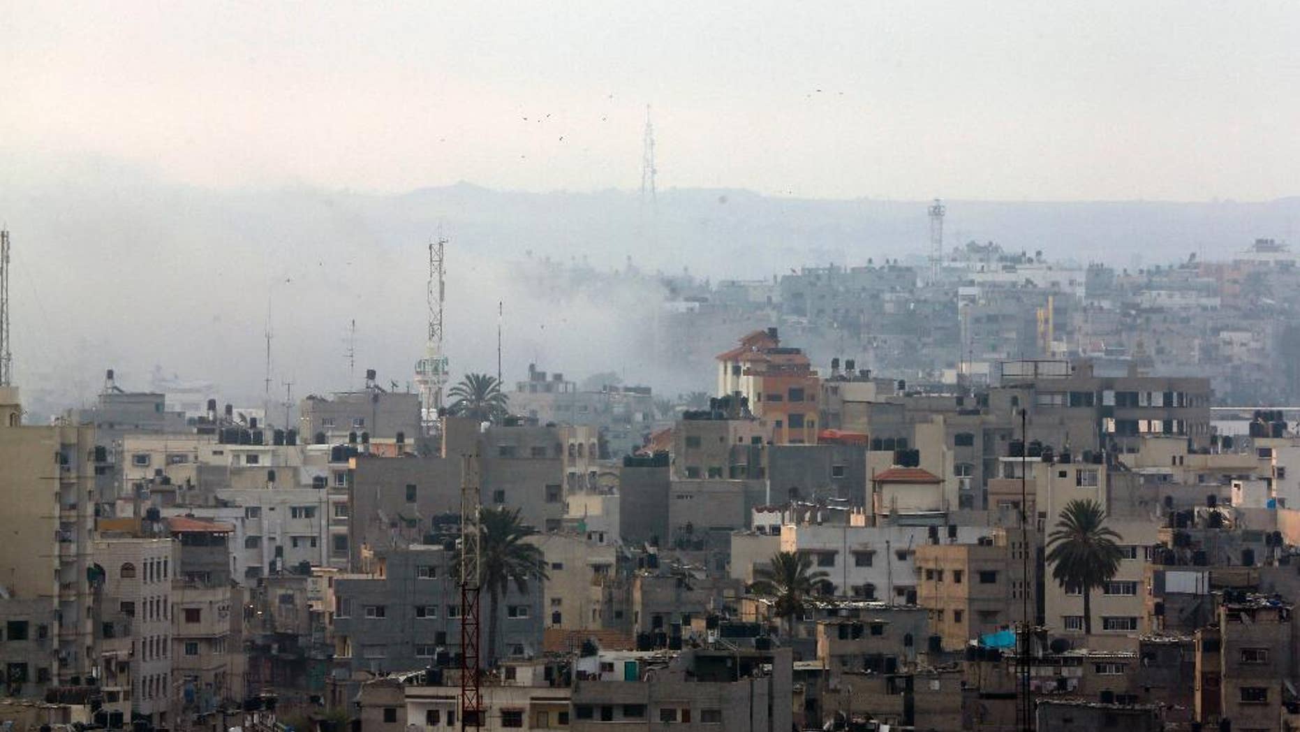 Smoke from Israeli strikes rises over Gaza City , northern Gaza Strip, Sunday, July 20, 2014. Israel said it widened its ground offensive early Sunday, sending more troops into Gaza after demolishing more than a dozen Hamas tunnels and intensifying tank fire on border areas. Since the start of Israel-Hamas fighting almost two weeks ago, over 300 Palestinians were killed and 2,700 wounded in Israeli air and artillery strikes, according to Palestinian health officials. One-fourth of the deaths were reported since the start of the ground offensive late Thursday, the officials said.(AP Photo/Lefteris Pitarakis)