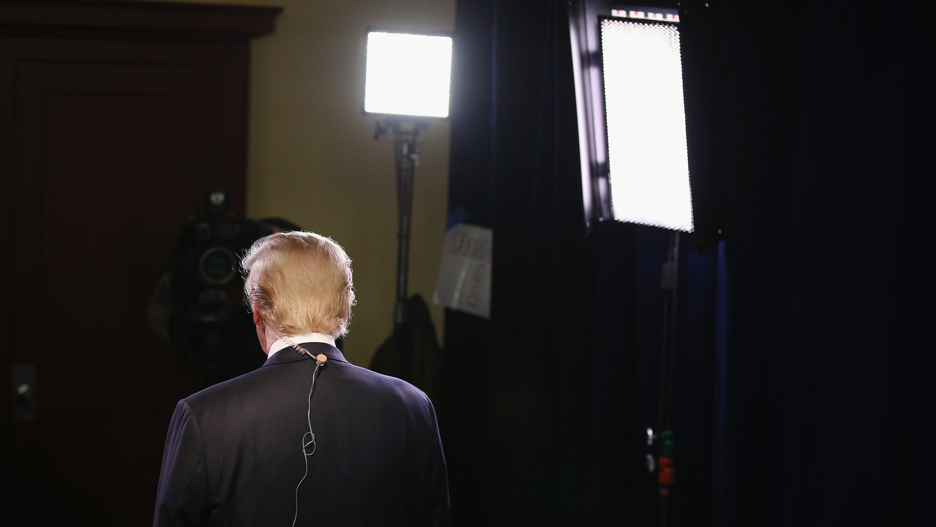 MILWAUKEE, WI - NOVEMBER 10: Republican presidential candidate Donald Trump gives an interview in the spin room after the Republican Presidential Debate sponsored by Fox Business and the Wall Street Journal at the Milwaukee Theatre on November 10, 2015 in Milwaukee, Wisconsin. The fourth Republican debate is held in two parts, one main debate for the top eight candidates, and another for four other candidates lower in the current polls. (Photo by Scott Olson/Getty Images)
