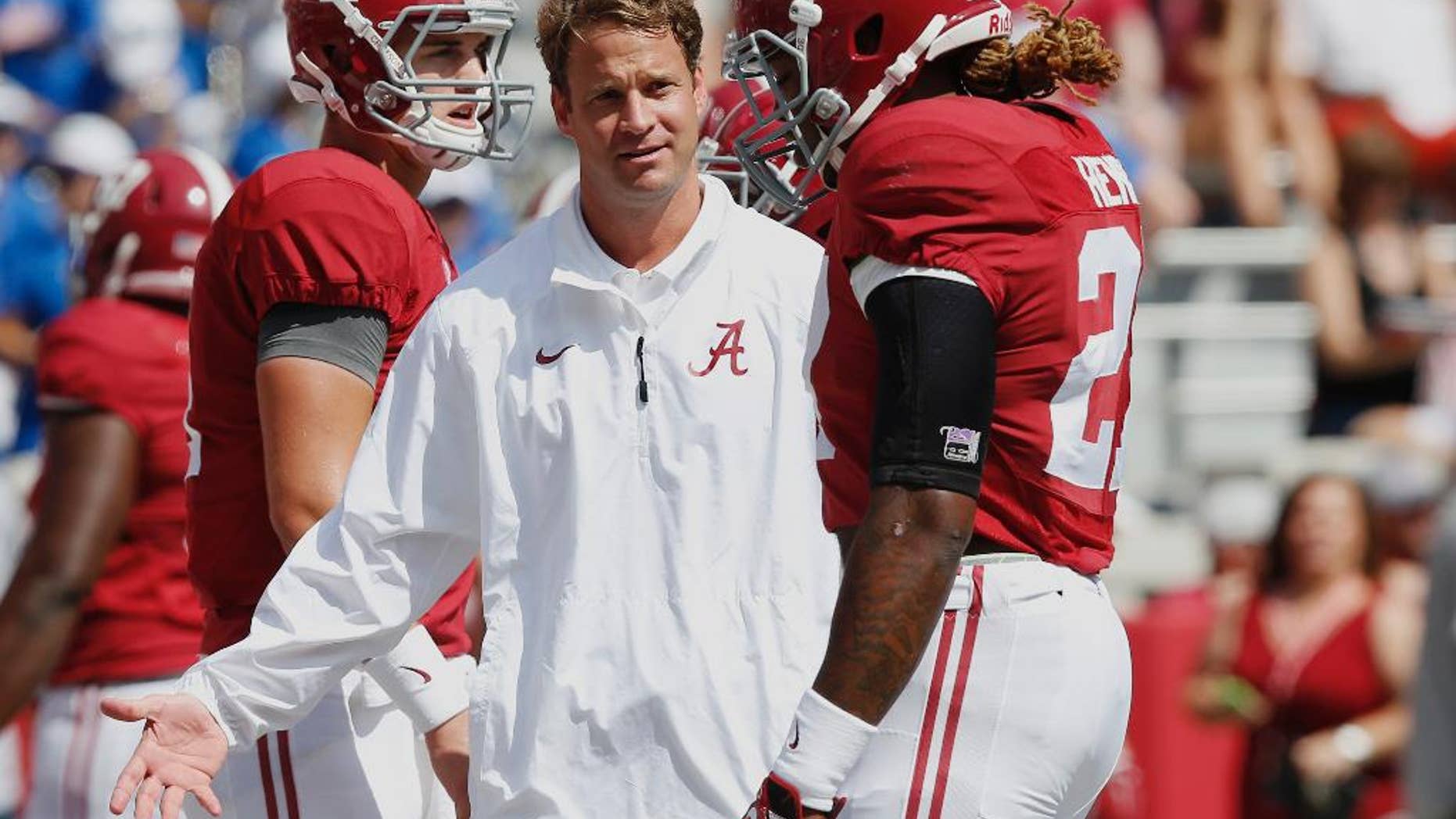 Alabama's offensive coordinator Lane Kiffin, centerr, gestures at running back Derrick Henry (27) before an NCAA college football game against Florida, Saturday, Sept. 20, 2014, in Tuscaloosa, Ala. (AP Photo/Brynn Anderson)