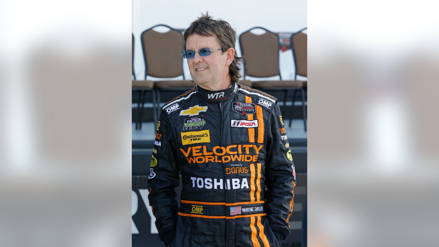 Driver Wayne Taylor talks with others drivers before a photo session after practice for the IMSA Series Rolex 24 hour auto race at Daytona International Speedway in Daytona Beach, Fla., Friday, Jan. 24, 2014.(AP Photo/John Raoux)