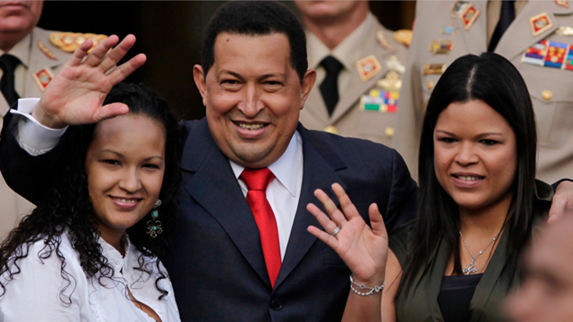 July 15: Venezuela President Hugo Chavez waves flanked by his daughters Rosa Virginia, right, and Gabriela, after he announced he will return to Cuba Saturday to begin a new phase of cancer treatment that will include chemotherapy at Miraflores presidential palace in Caracas, Venezuela.