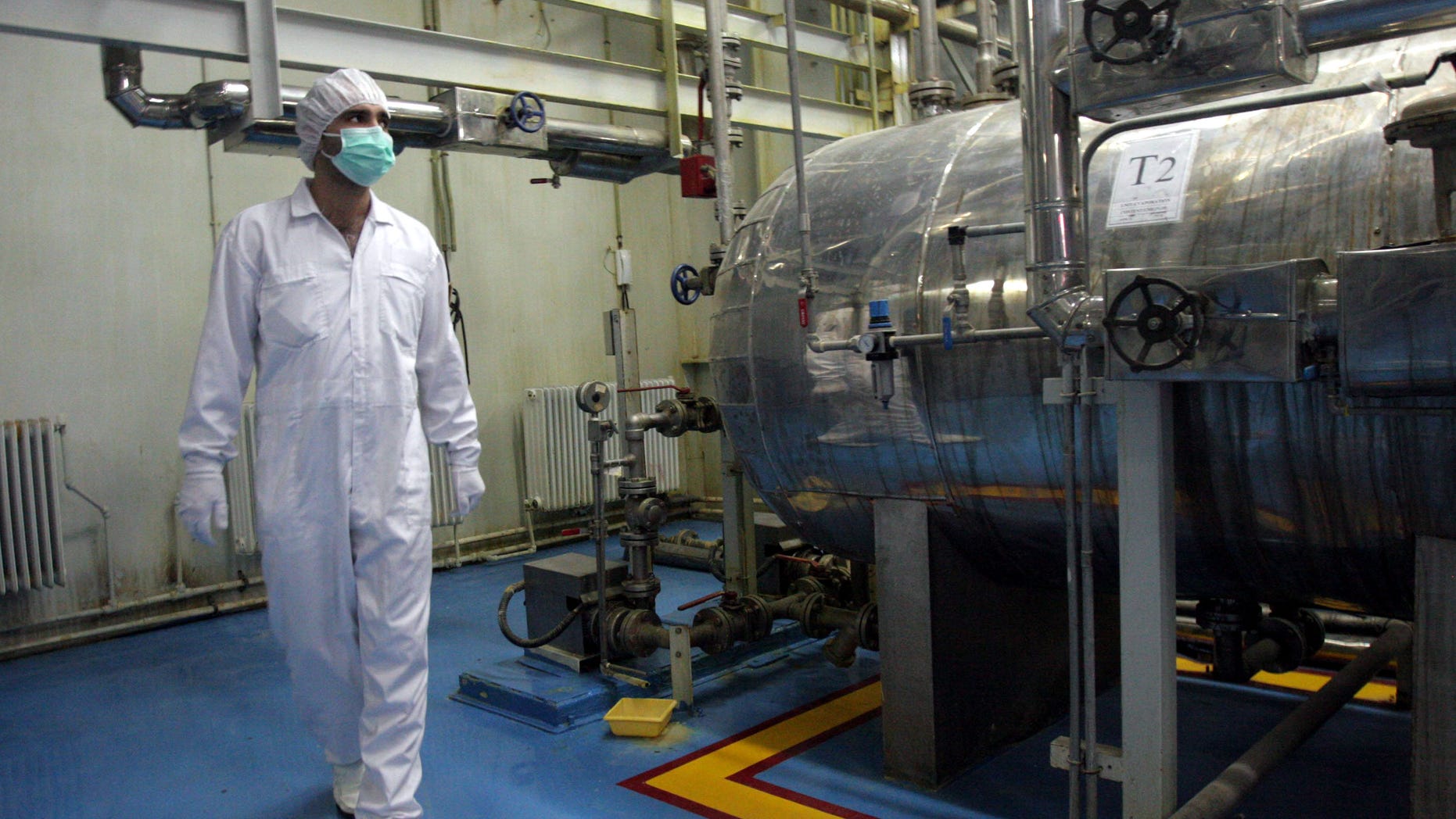 FILE - In this Feb. 2007 file photo, an Iranian technician walks through the Uranium Conversion Facility just outside the city of Isfahan 255 miles (410 kilometers) south of the capital Tehran, Iran. Israel has led the speculation that Iran could be moving closer to having all the pieces ready for a nuclear weapon. Israel also fears the negotiations could leave intact the mainstays of Iran's nuclear network: The ability to enrich uranium and produce atomic fuel. (AP Photo/Vahid Salemi, File)