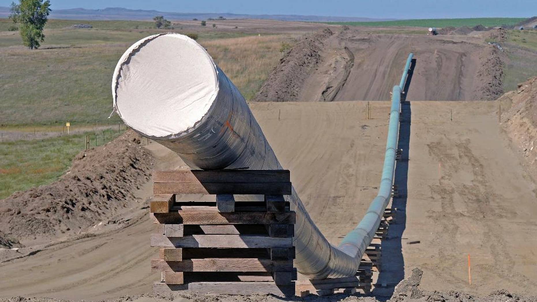 FILE - This Sept. 29, 2016 file photo, shows a section of the Dakota Access Pipeline under construction near the town of St. Anthony in Morton County, N.D. Texas-based Energy Transfer Partners, the company building the oil pipeline, asked a a federal judge on Tuesday, Jan. 17, 2017, to block the U.S. Army Corps of Engineers from launching a full environmental study of the $3.8 billion pipeline's disputed crossing of a Missouri River reservoir in North Dakota. (Tom Stromme/The Bismarck Tribune via AP, File)