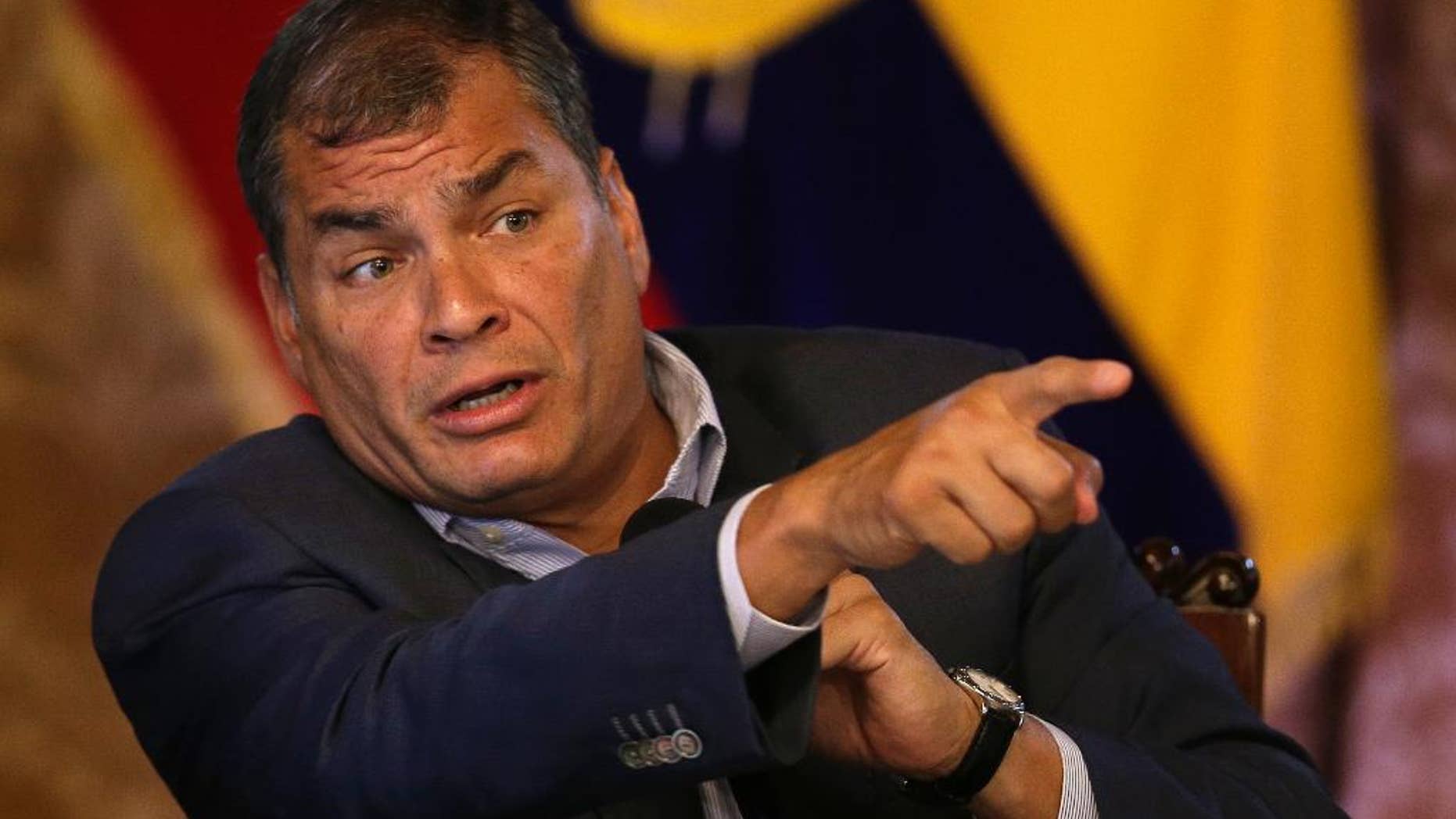 FILE - In this June 8, 2016, file photo, Ecuador's President Rafael Correa points during a press conference in Quito, Ecuador. An Ecuadorean journalist convicted of libeling President Rafael Correa said on Thursday, Aug. 11, that he is broke and must take up a public collection to pay the $141,000 judgment. (AP Photo/Dolores Ochoa, File)