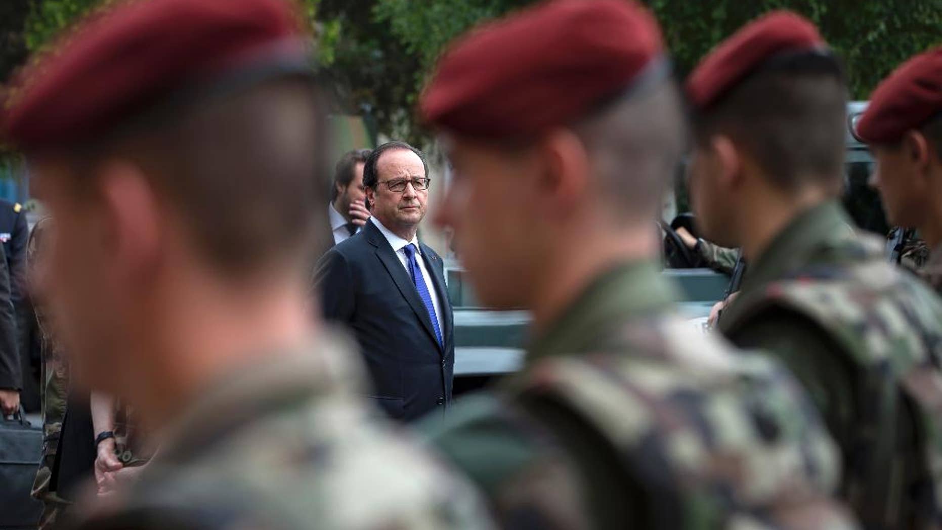 French president Francois Hollande reviews troops at the army base and command center for France's anti-terror 'Vigipirate' plan, dubbed 'Operation Sentinelle', in Vincennes, outside Paris, in July.