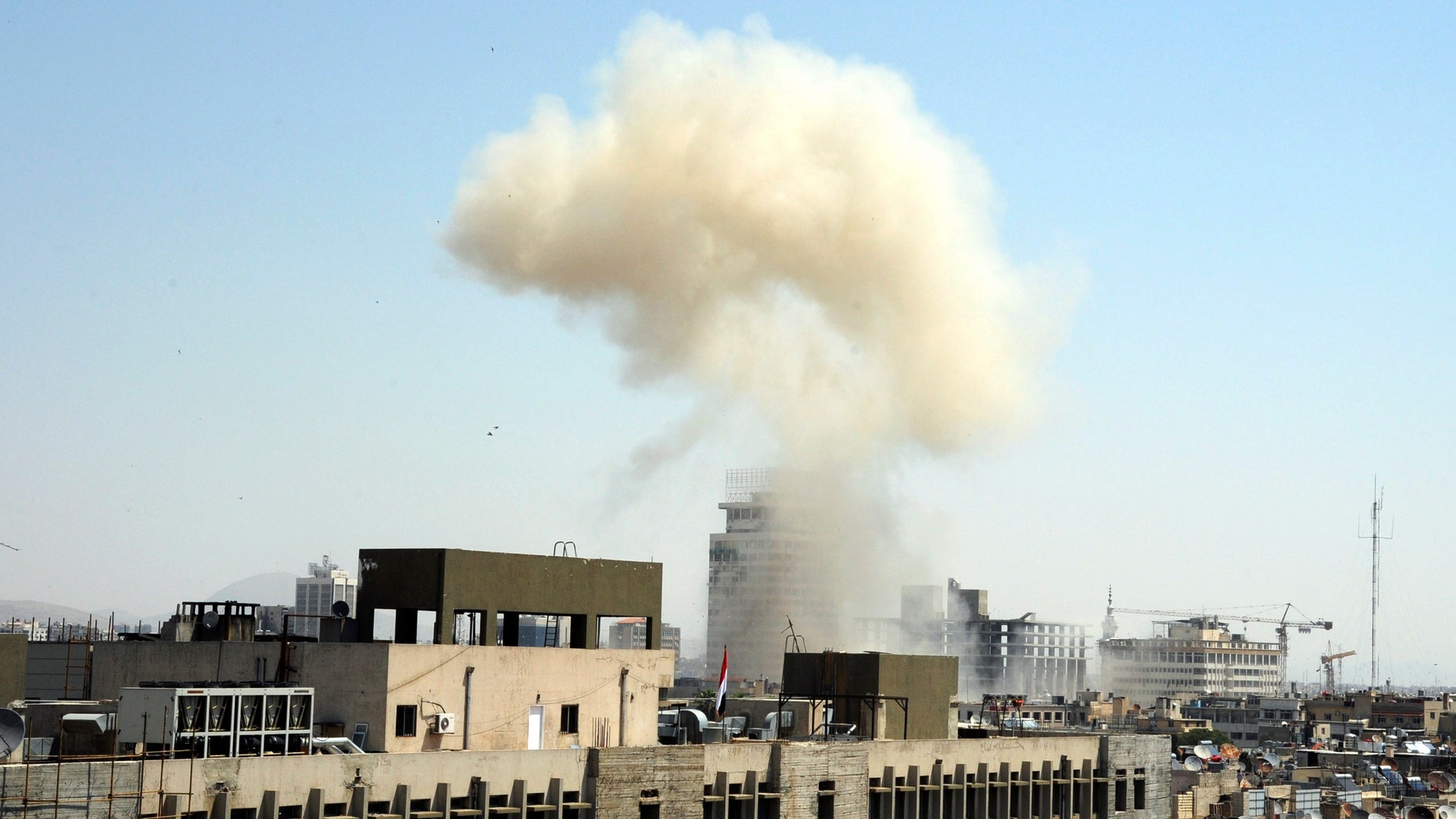 This photo released by the Syrian official news agency SANA, shows billowing smoke from a powerful explosion that shook Damascus in the central Marjeh district of Damascus, Syria, Tuesday, April. 30, 2013. State TV said the explosion caused casualties. The blast comes a day after the Syrian Prime Minister narrowly escaped an assassination attempt a heavily protected area of Damascus. (AP Photo/SANA)