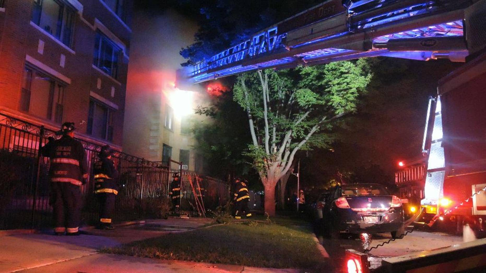 Chicago firefighters battle an apartment fire in the 8100 block of South Essex Avenue in the South Chicago neighborhood early on Tuesday, Aug. 23, 2016. The fire at a Chicago apartment building that appears to have been deliberately set killed multiple people Tuesday, police said. (Alexandra Chachkevitch/Chicago Tribune via AP)