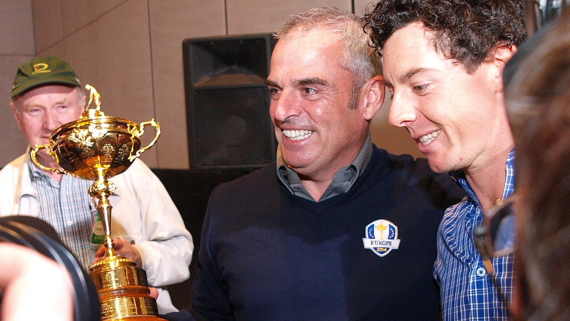 Rory McIlroy, right, congratulates Paul McGinley of Ireland, holding the Ryder Cup, after he was nominated as the Captain for the 2014 European Ryder Cup Team following a meeting of the Tournament Committee of the European Tour in Abu Dhabi, United Arab Emirates, Tuesday, Jan. 15, 2013. (AP Photo/Manuel Salazar)