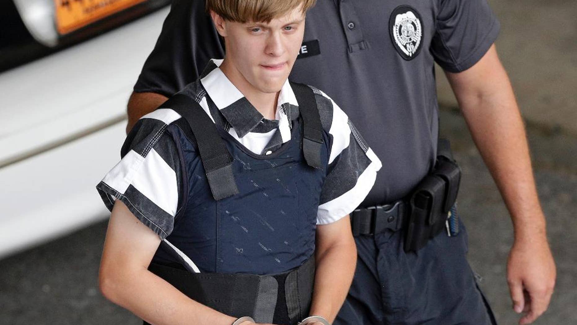 FILE - In this June 18, 2015 file photo, Charleston, S.C., shooting suspect Dylann Storm Roof is escorted from the Cleveland County Courthouse in Shelby, N.C. The sentencing phase of Roof's federal trial begins Wednesday, Jan. 4, 2016, in Charleston. He could face the death penalty or life in prison. (AP Photo/Chuck Burton, File)