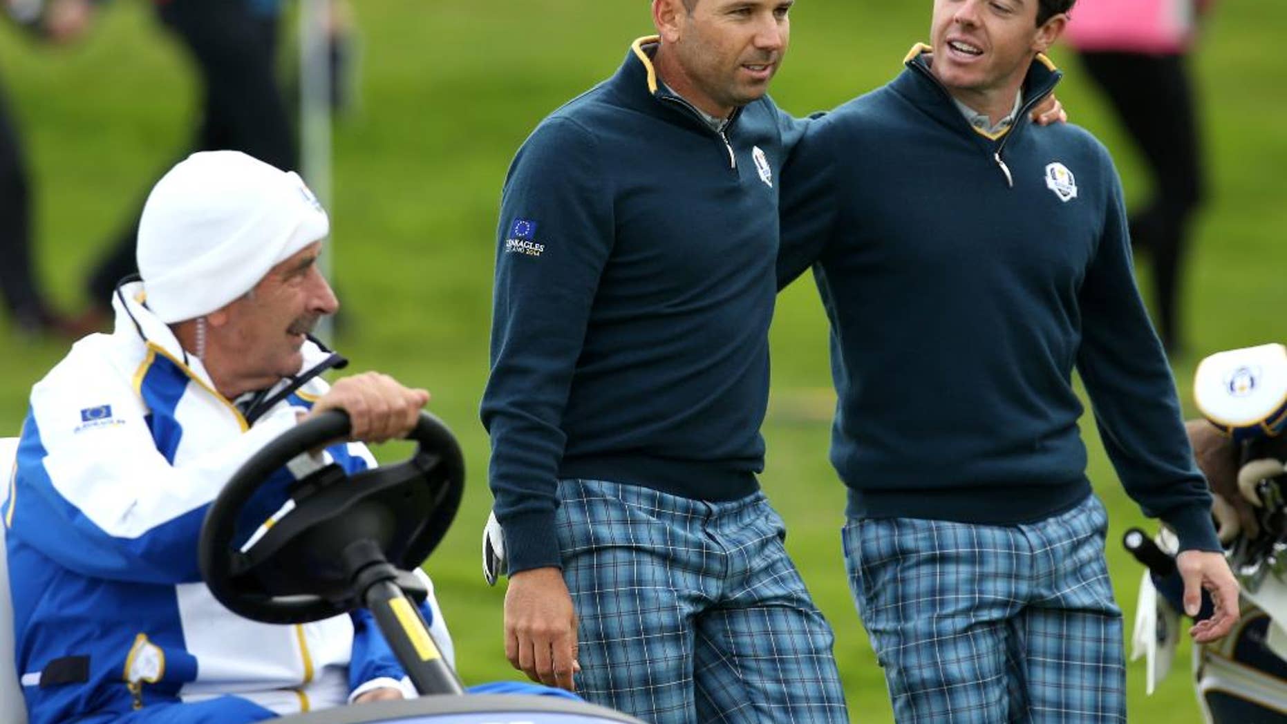 Europe’s Rory McIlroy, right, and Sergio Garcia walk alongside team vice captain Sam Torrance in a golf buggy on the 15th fairway during a practice round ahead of the Ryder Cup golf tournament at Gleneagles, Scotland, Tuesday, Sept. 23, 2014. (AP Photo/Peter Morrison)