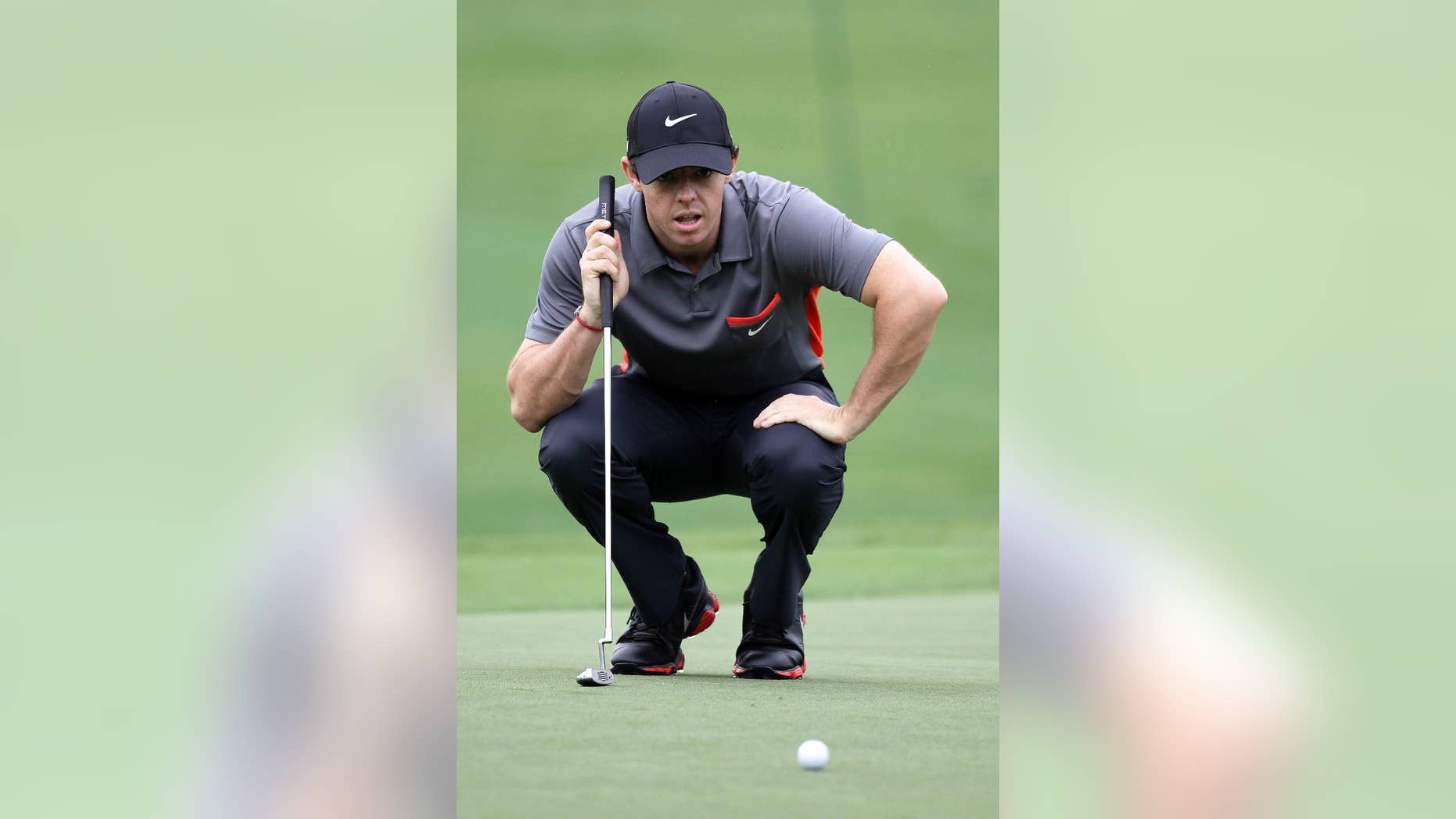 Rory McIlroy eyes his putt on the 18th green during the pro-am of the Wells Fargo Championship golf tournament at Quail Hollow Club in Charlotte, N.C., Wednesday, April 30, 2014. (AP Photo/Bob Leverone)