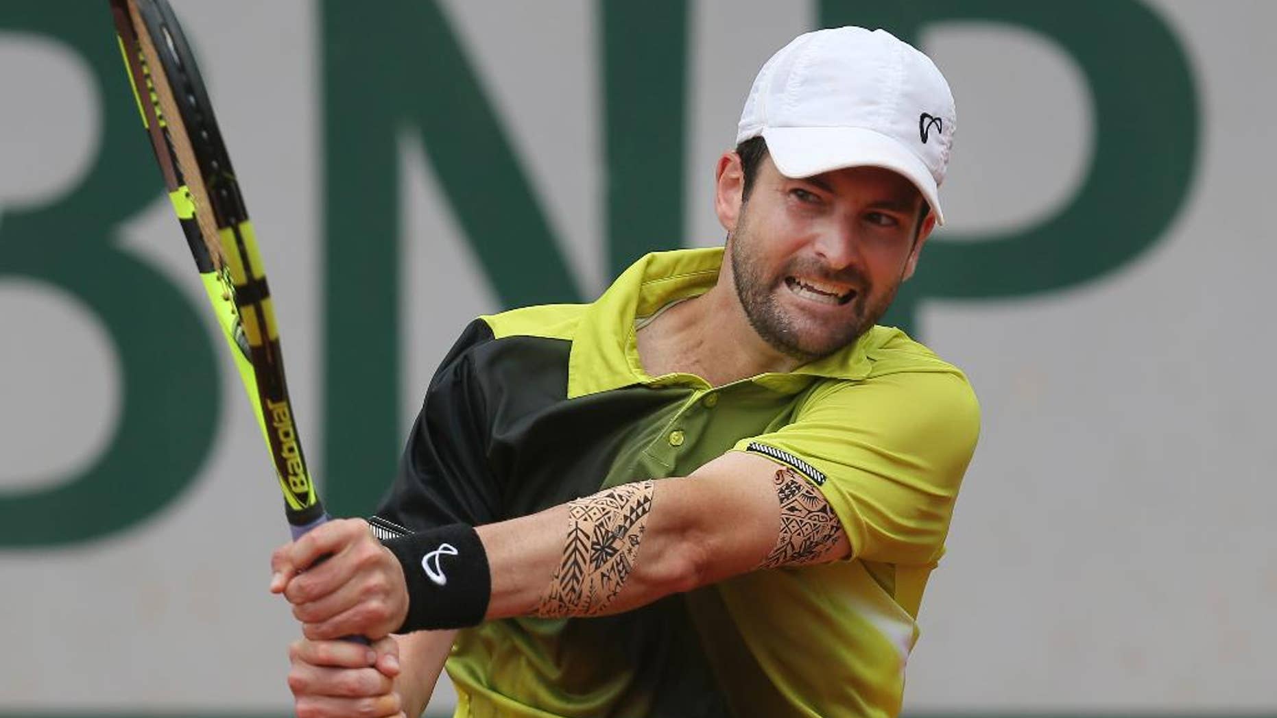 FILE - In this May 24, 2016 file photo, Brian Baker of the U.S. returns in his first round match of the French Open tennis tournament against Australia's Bernard Tomic at the Roland Garros stadium in Paris, France. Baker, whose promising career has been derailed by injuries, is 334th in the world but used a provision known as a protected ranking to take advantage of the opportunity to play at the 2016 Rio Summer Olympics. (AP Photo/David Vincent, File)