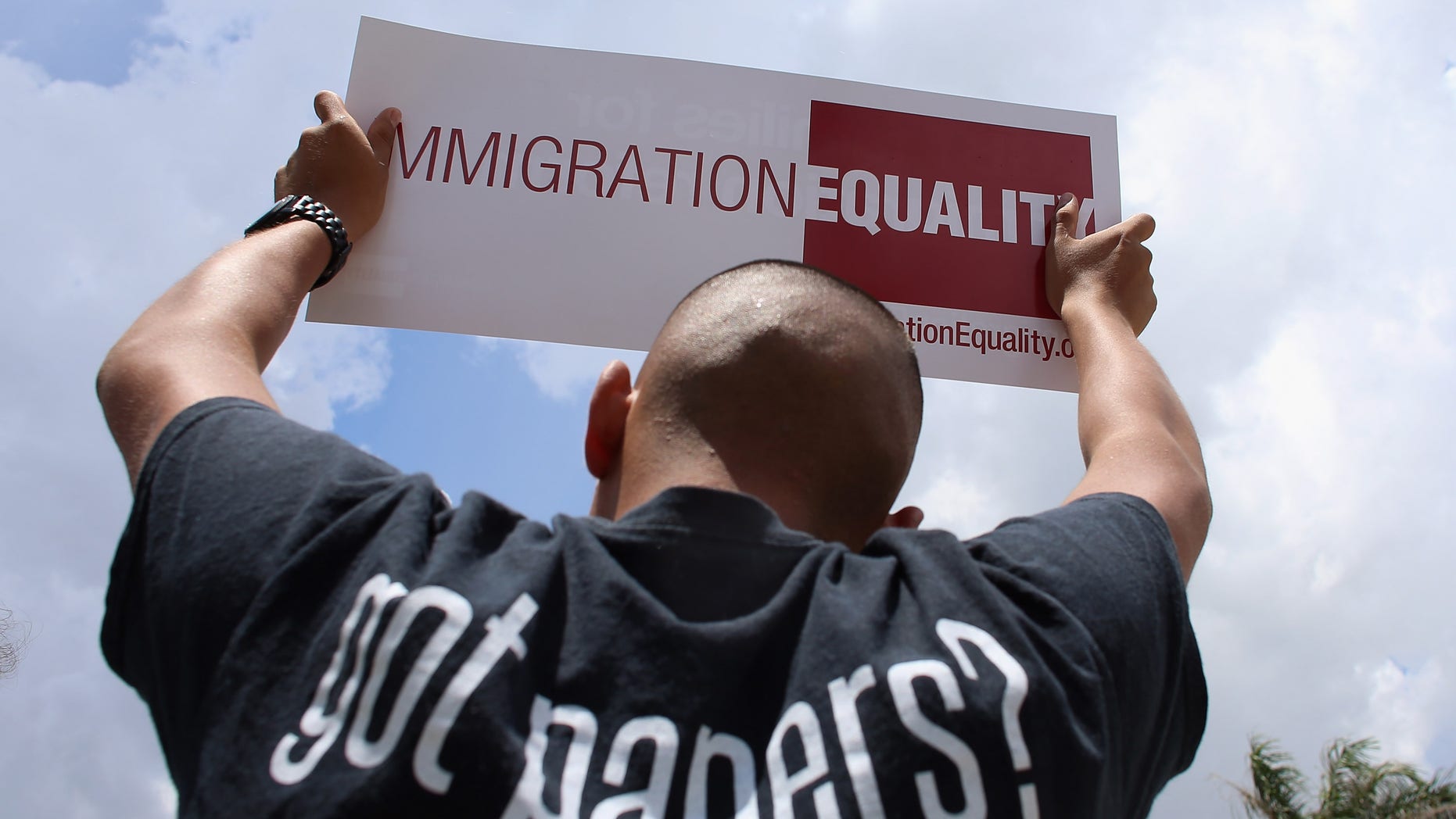 DORAL, FL - MAY 22: Protesters make themselves heard in front of Sen. Marco Rubio's (R-FL) office on May 22, 2013 in Doral, Florida. The protesters are asking Rubio to stop opposing the inclusion of lesbian, gay, bisexual and transgender (LGBT) families in the Senate?s comprehensive immigration reform bill. (Photo by Joe Raedle/Getty Images)