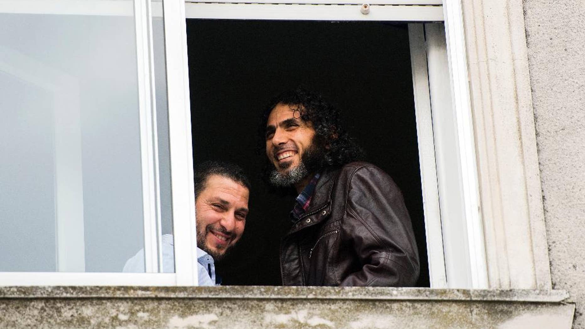FILE - In this June 5, 2015 file photo, Abu Wa'el Dhiab, from Syria, right, and Adel bin Muhammad El Ouerghi, of Tunisia, both freed Guantanamo Bay detainees, stand next to the window of their shared home in Montevideo, Uruguay. The new U.S. ambassador in Uruguay expressed concern on Monday, July 11, 2016, about the lack of information on the whereabouts of Abu Wa'el Dhiab. (AP Photo/Matilde Campodonico, File)
