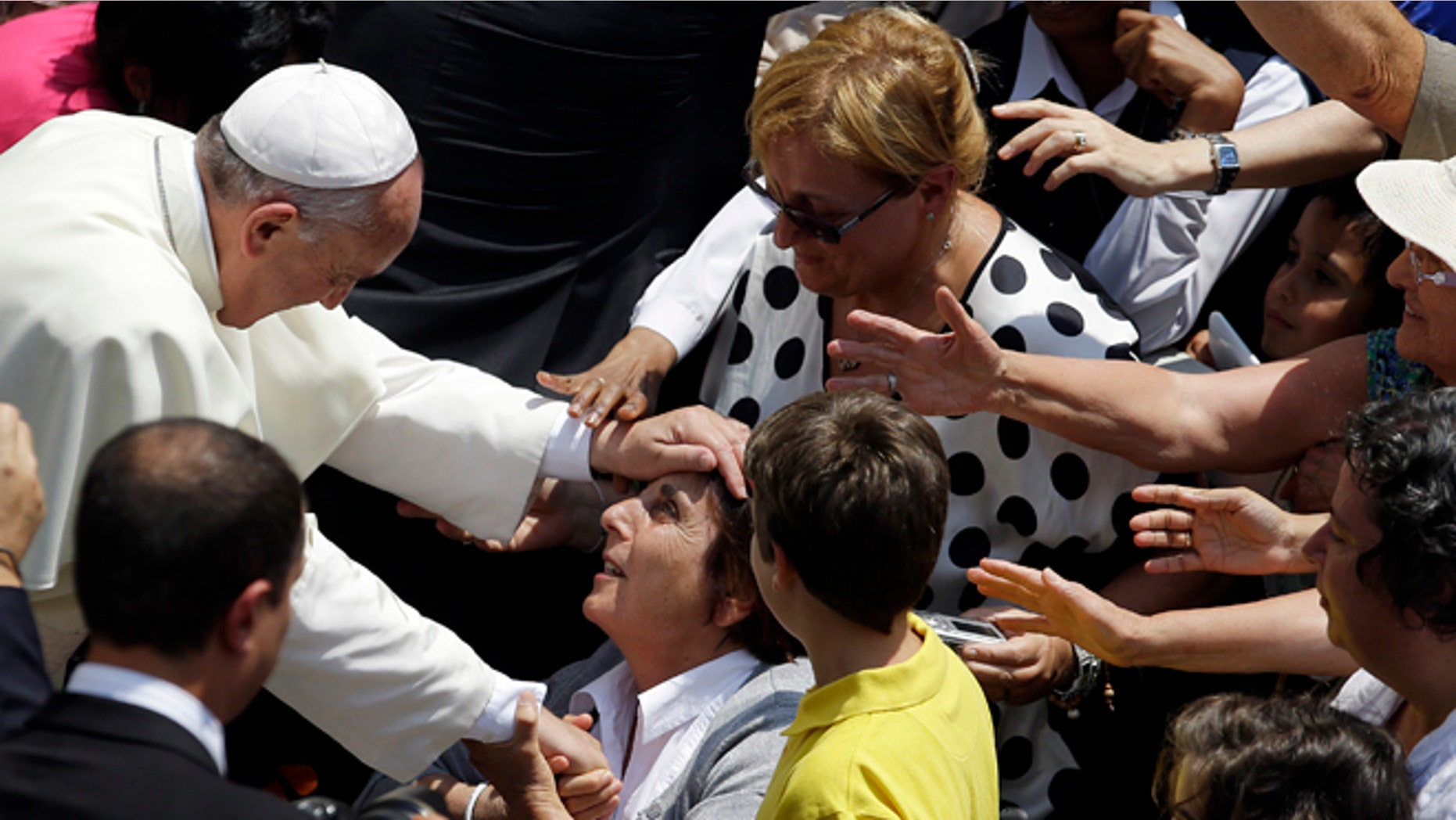 July 14, 2013: Pope Francis blesses a faithful after he delivered the Angelus prayer at the Pontiff's residence of Castel Gandolfo, near Rome.
