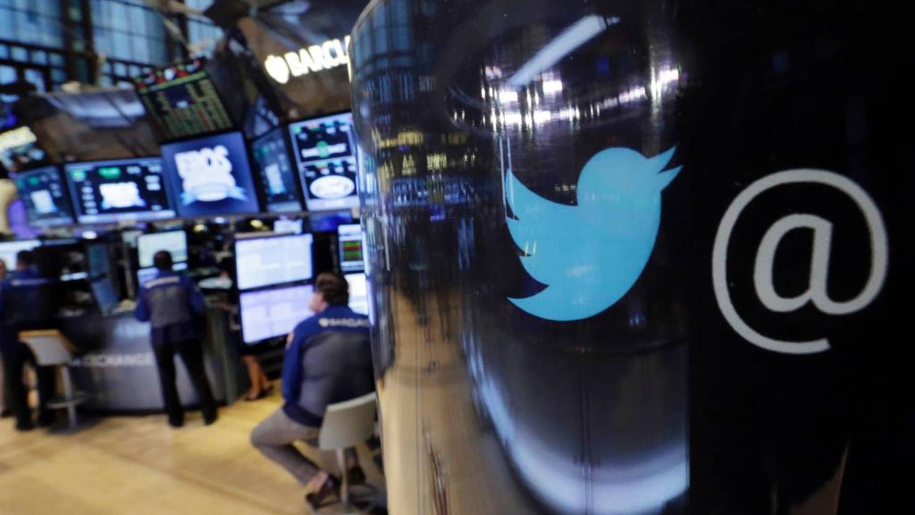 FILE - In this Tuesday, Oct. 13, 2015, file photo, the Twitter logo appears on a phone post on the floor of the New York Stock Exchange. Twitter said Thursday, Aug. 18, 2016, it has suspended 360,000 accounts since mid-2015 for violating its policies banning the promotion of terrorism and violent extremism. (AP Photo/Richard Drew, File)