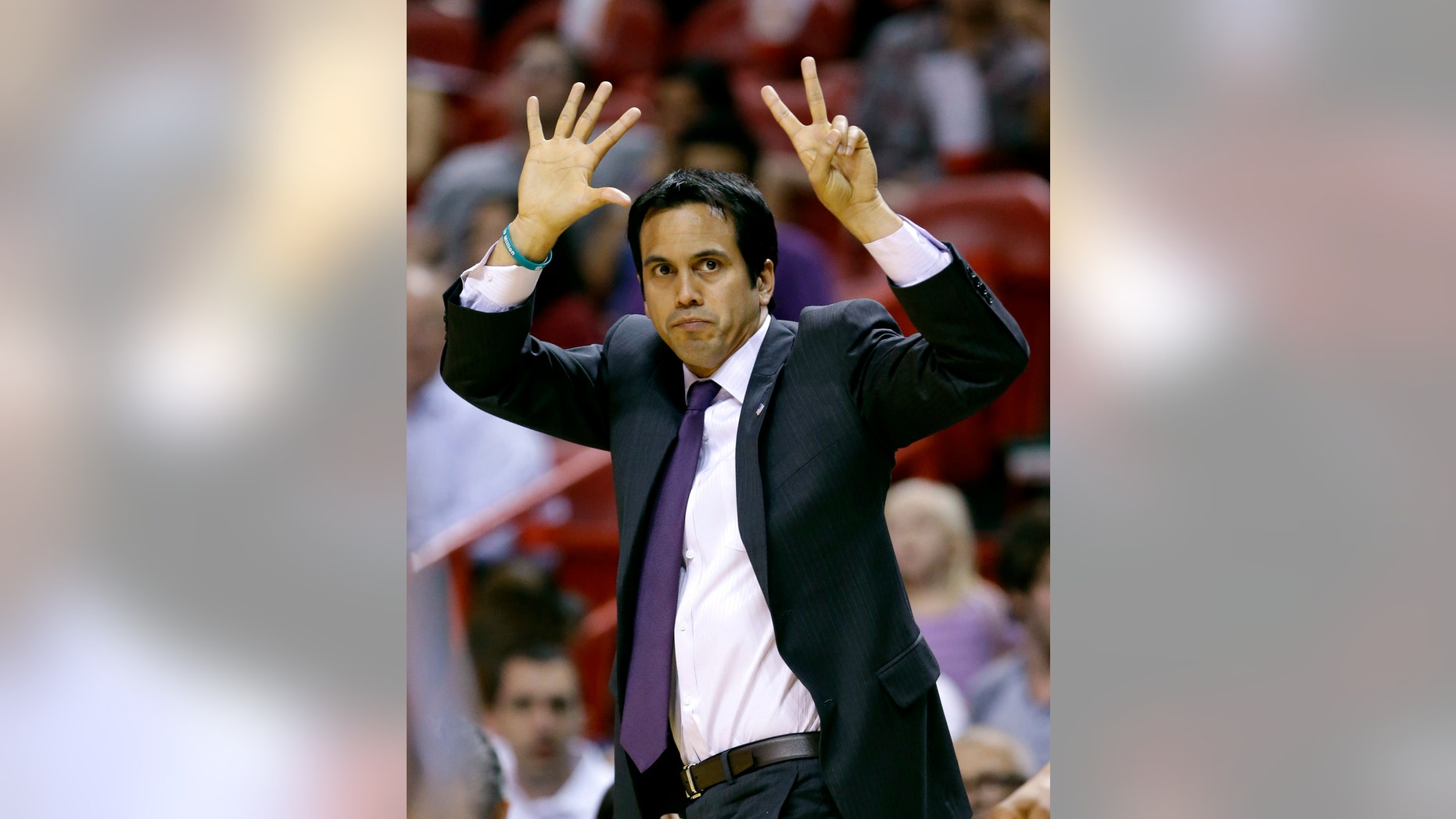 FILE - In this April 17, 2013 file photo, Miami Heat head coach Erik Spoelstra calls out a play during the first half of an NBA basketball game against the Orlando Magic in Miami. Only six coaches in NBA history have won back-to-back championships, a club that Erik Spoelstra would be joining if the Miami Heat find a way to win the title again this year. (AP Photo/Wilfredo Lee, File)