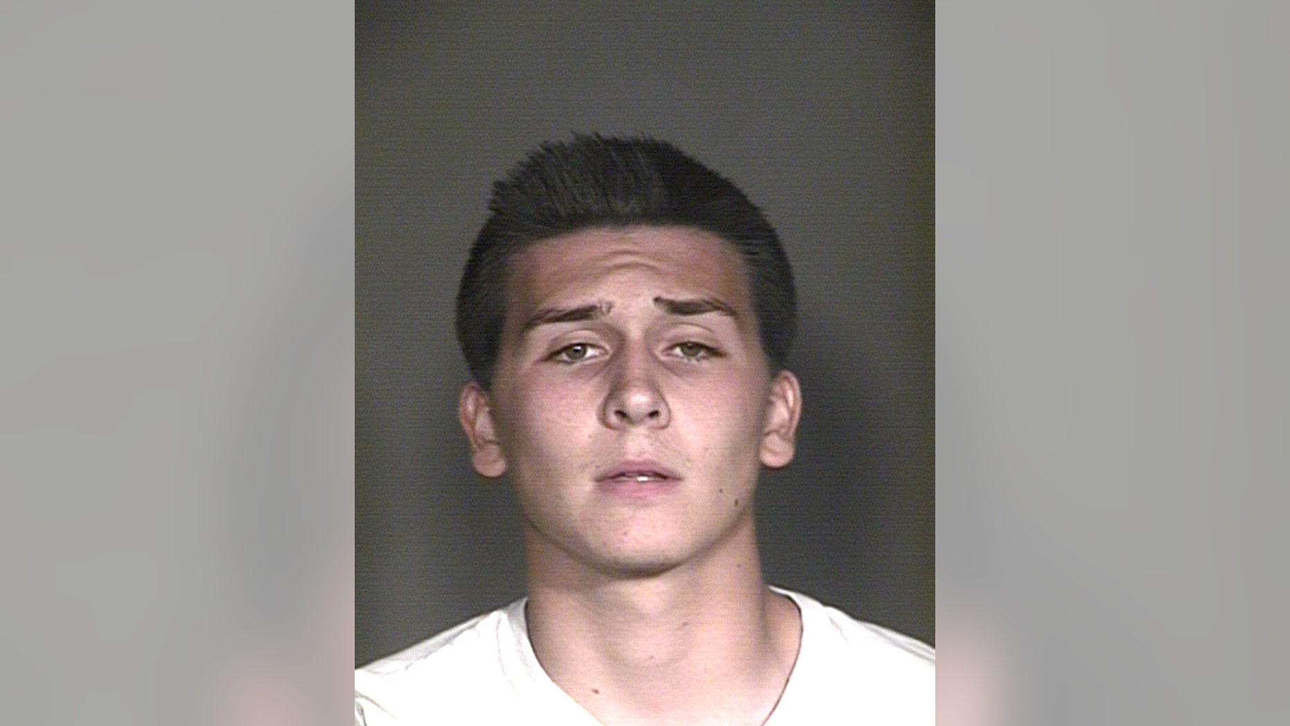 This undated booking photo provided by the Mesa Police Department, in Mesa, Ariz., shows Hunter Osborn. The Arizona high school student is facing dozens of charges after police say he exposed himself in a football team picture that ended up in a yearbook handed out to some 3400 students. (Mesa Police Department via AP)