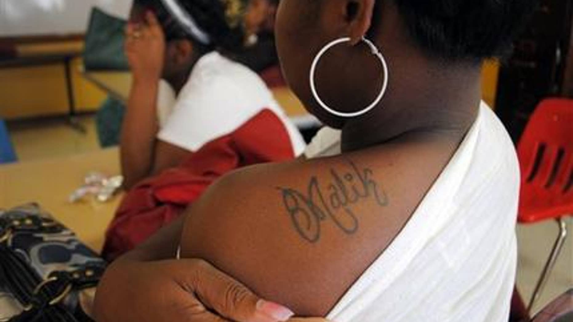 In this May 2, 2012 photograph taken in Marks, Miss., Shalendrick Tribble, 19, shows off a tattoo of her son's name in a classroom at Madison S. Palmer High School in Marks. Tribble had her son almost two years ago, and has been taking classes in parenting and family planning. (AP Photo/Laura Tillman)