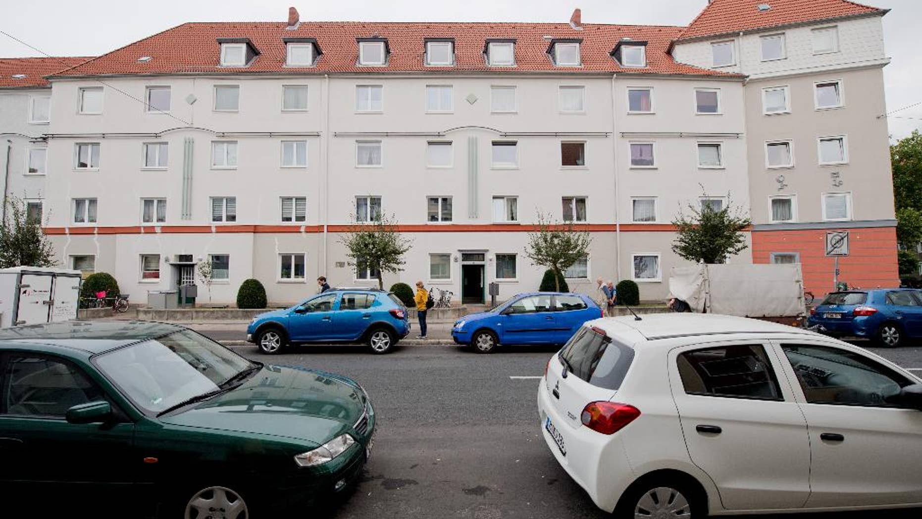 A residential house in the borough of Vahrenwald in Hannover, Germany, Friday, Sept. 30, 2016. The skeleton of a dead newborn and a living baby have been found in a suitcase inside a flat of the residential house. (Julian Stratenschulte/dpa via AP)