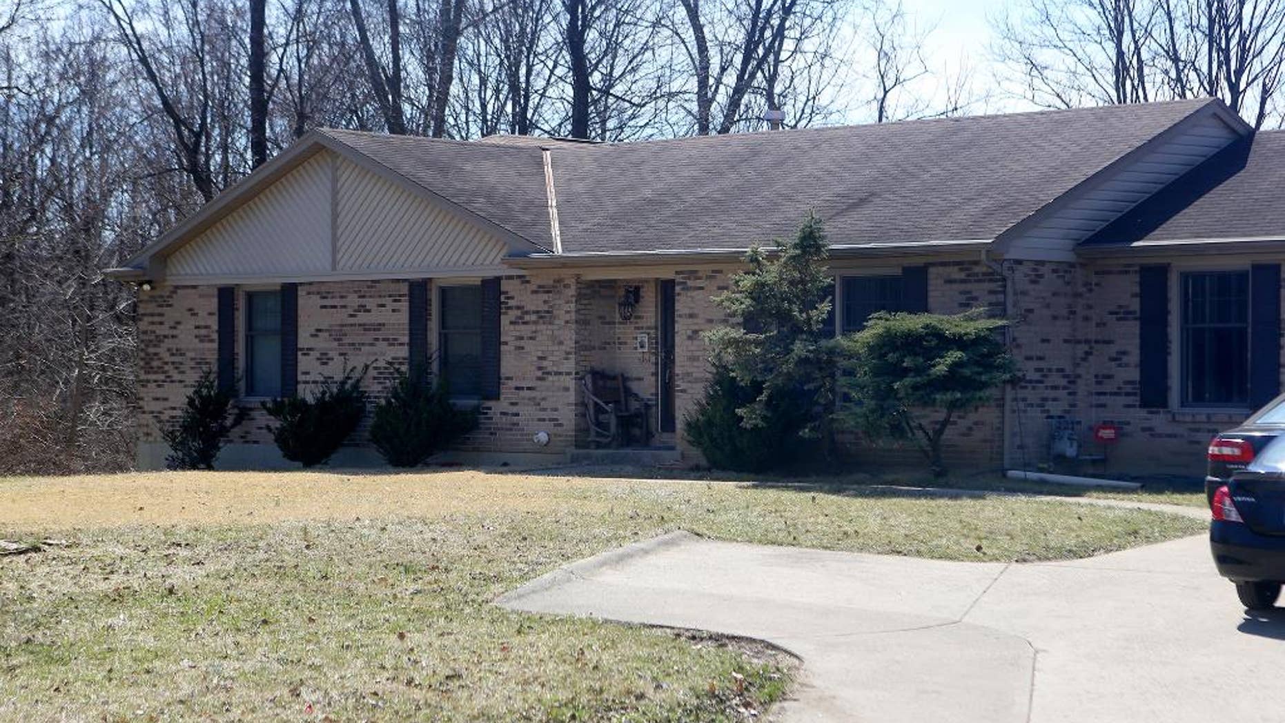This Tuesday, March 17, 2015 photo shows the College Hill home where a three-month old baby was found murdered in Cincinnati. Police arriving in response to a 911 call found the baby decapitated and stabbed multiple times with a large chef's knife. Deasia Watkins, the 20-year-old mother, was found in bed covered with blood, Hamilton County prosecutor Joe Deters said. She was arrested and charged with aggravated murder. (AP Photo/The Cincinnati Enquirer, Amanda Rossmann) MANDATORY CREDIT; NO SALES