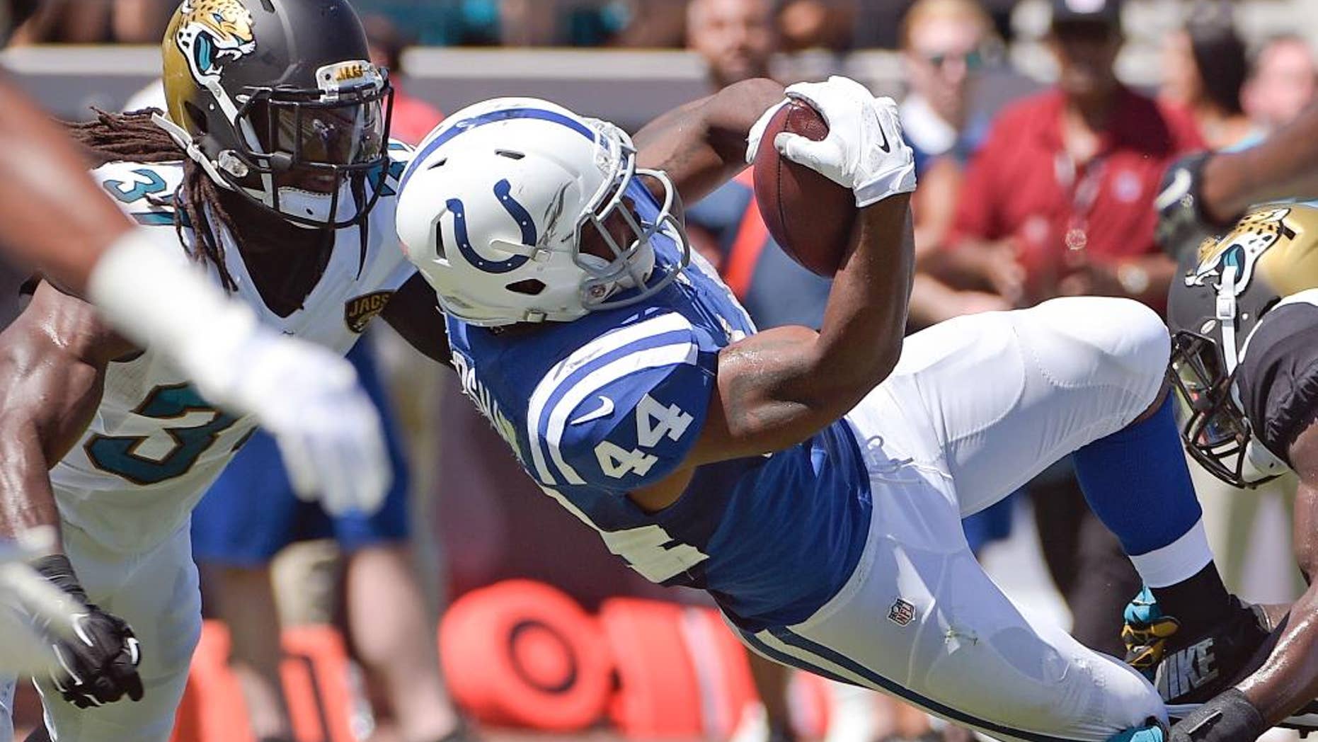 Indianapolis Colts running back Ahmad Bradshaw (44) gets past Jacksonville Jaguars strong safety Johnathan Cyprien (37) for a touchdown on a 6-yard pass play during the first half of an NFL football game in Jacksonville, Fla., Sunday, Sept. 21, 2014. (AP Photo/Phelan M. Ebenhack)