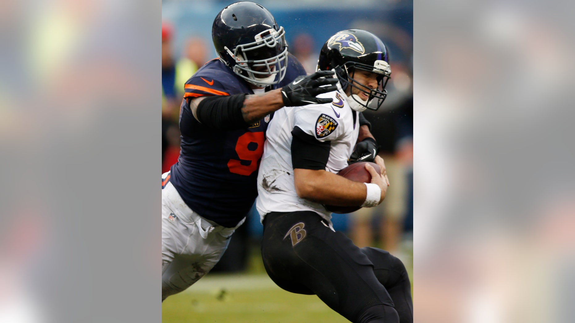 Chicago Bears defensive end Julius Peppers (90) sacks Baltimore Ravens quarterback Joe Flacco (5) during the first half of an NFL football game, Sunday, Nov. 17, 2013, in Chicago. (AP Photo/Charles Rex Arbogast)