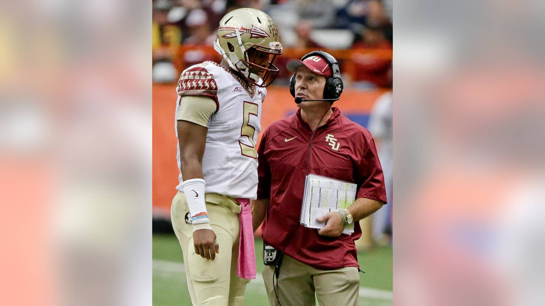 Florida State head coach Jimbo Fisher, right, talks to quarterback Jameis Winston (5) during the second half of an NCAA college football game against Syracuse, Saturday, Oct. 11, 2014, in Syracuse, N.Y. Florida State won the game 38-20. (AP Photo/Frank Franklin II)