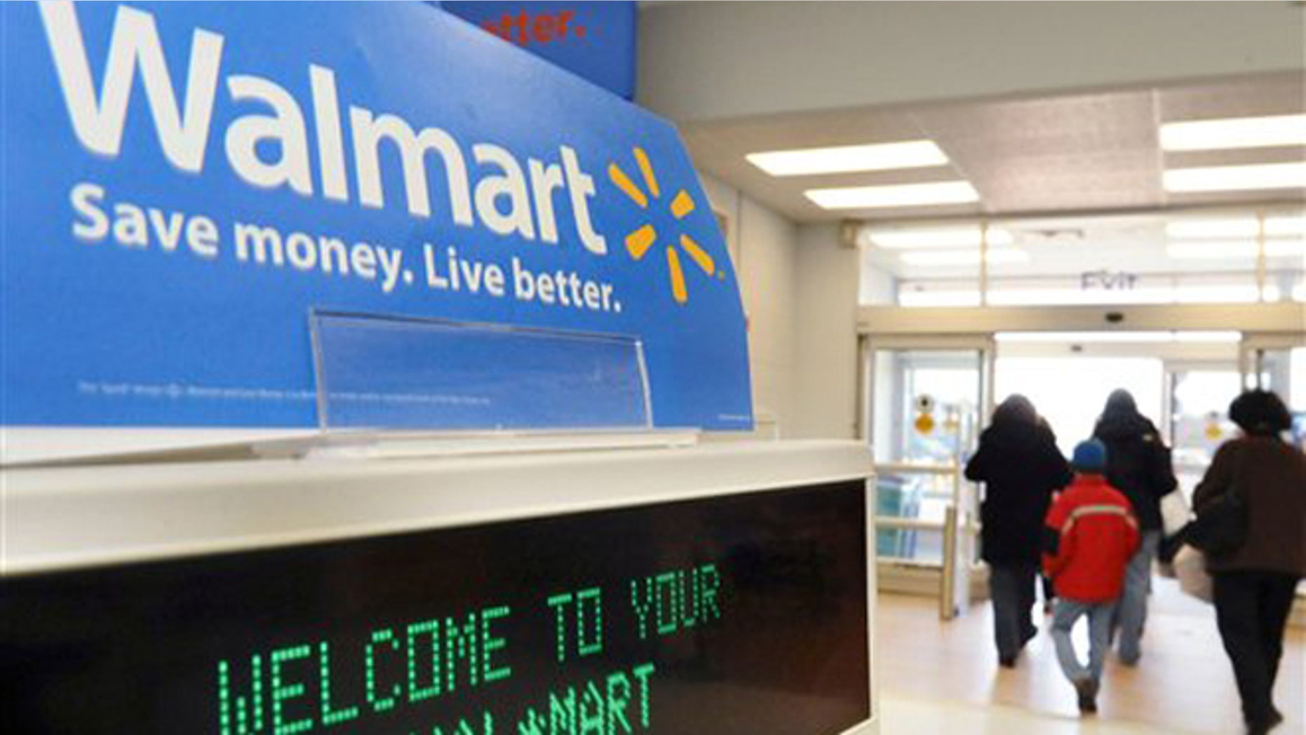 FILE - In this Feb. 17, 2009 file photo, shoppers leave a Wal-Mart store in Danvers, Mass. Wal-Mart has big hopes for a new effort to develop eco-ratings for products it sells _ one that goes far beyond its own stores. (AP Photo/Lisa Poole, file)