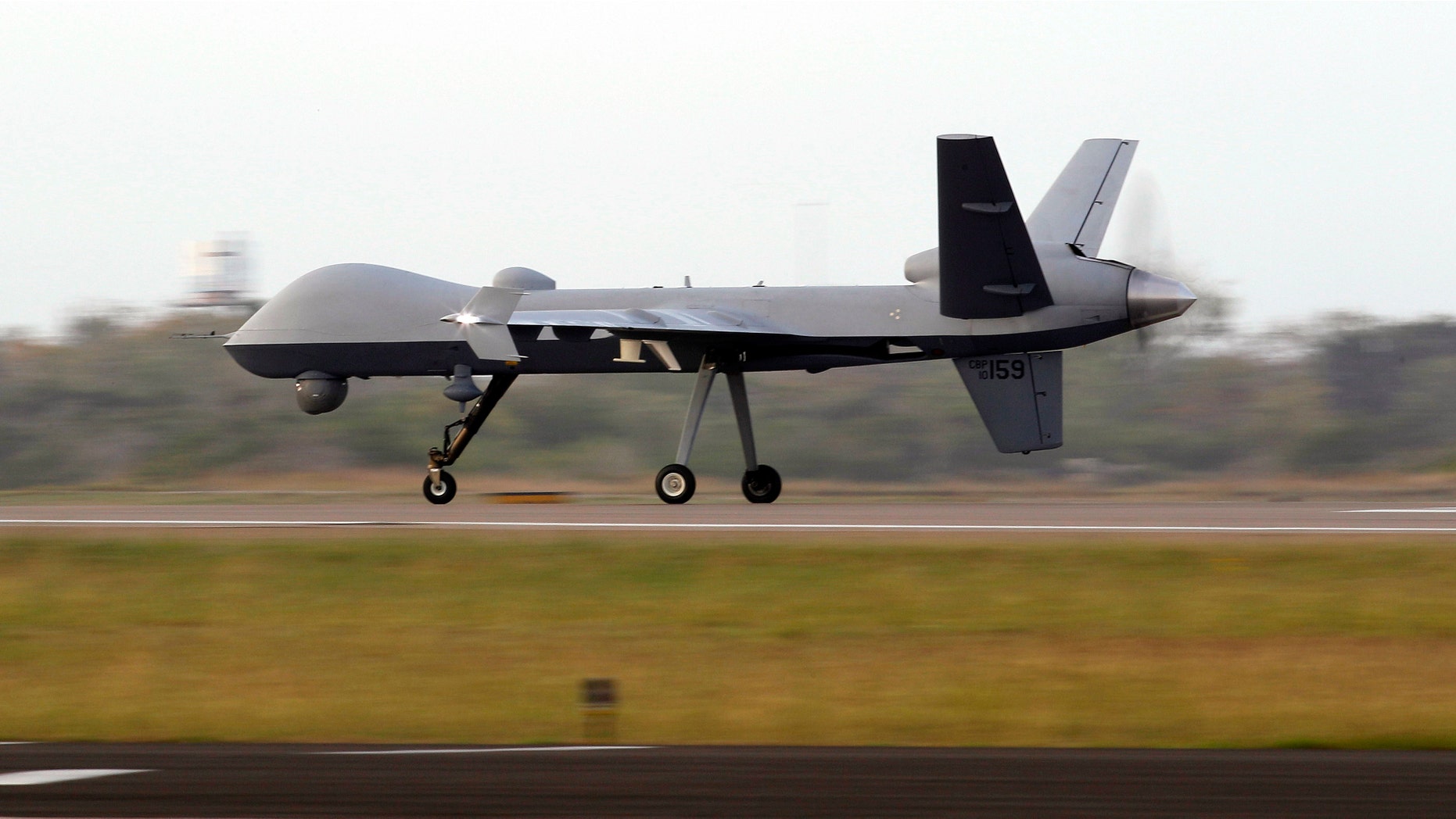 A Predator B unmanned aircraft lands after a mission at the Naval Air Station, Tuesday, Nov. 8, 2011, in Corpus Christi, Texas. Using the same technology responsible for lethal strikes elsewhere in the world, U.S. Customs and Border Protection is expanding its use of Predator B unmanned aircraft outfitted with powerful infrared cameras and sensitive radar to patrol U.S. borders. (AP Photo/Eric Gay)