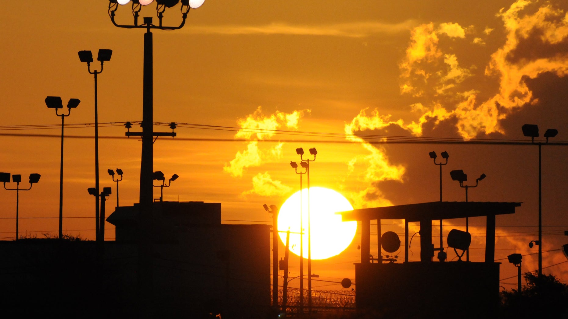 FILE - In this Oct. 18, 2012 file photo reviewed by the U.S. Department of Defense, towers overlooking a U.S. detention facility are silhouetted against a morning sunrise at Guantanamo Bay U.S. Naval Base, Cuba. A Republican-led Senate panel on Feb. 12, 2015, narrowly approved legislation that would bar most transfers of terror suspects from the U.S. prison at Guantanamo Bay, Cuba, a major roadblock in President Barack Obamas push to close the detention center.(AP Photo/Toronto Star, Michelle Shephard, File)