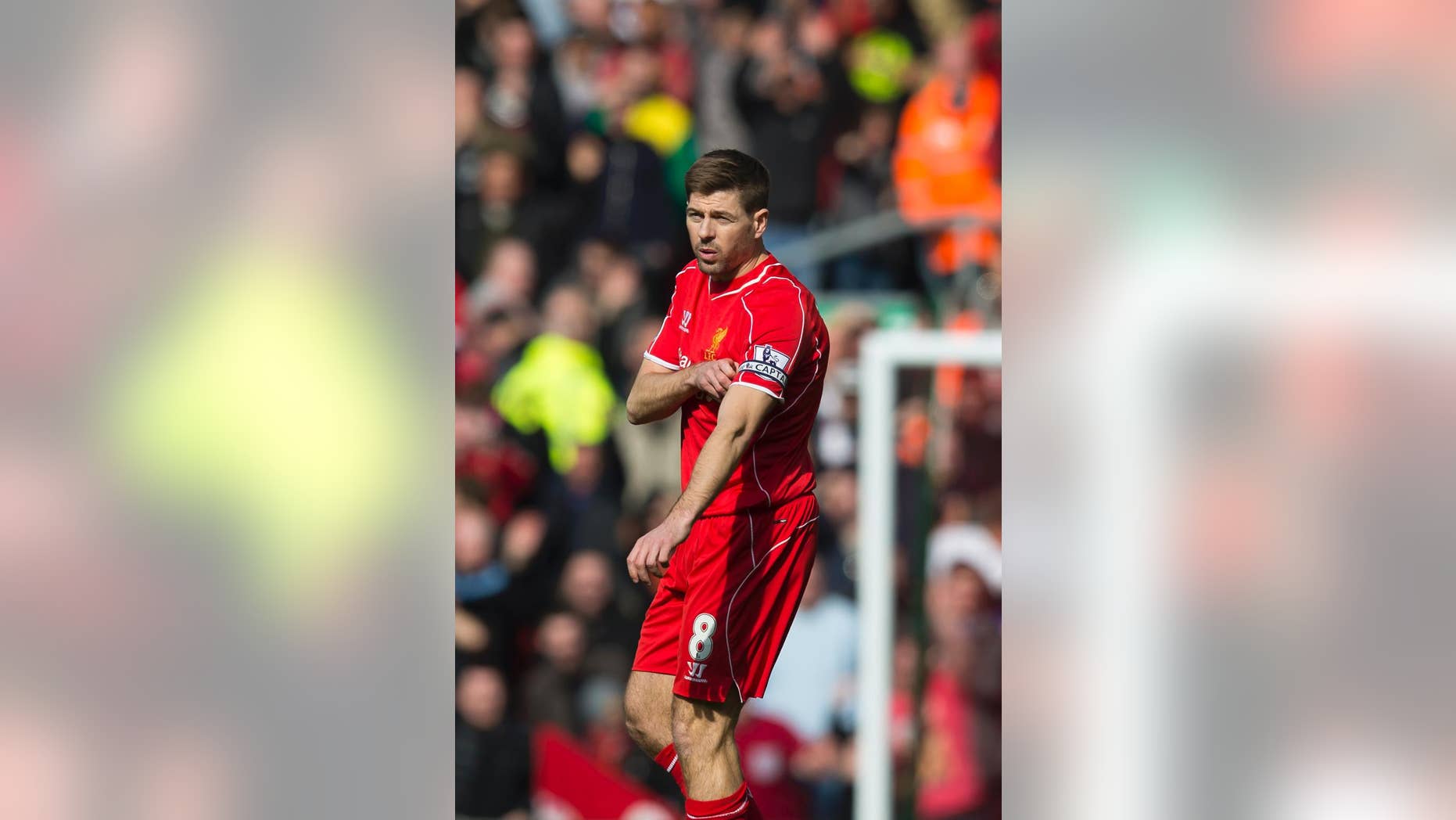 Liverpool's Steven Gerrard removes the captains armband after being sent off by referee Martin Atkinson during the English Premier League soccer match between Liverpool and Manchester United at Anfield Stadium, Liverpool, England, Sunday, March 22, 2015. (AP Photo/Jon Super)