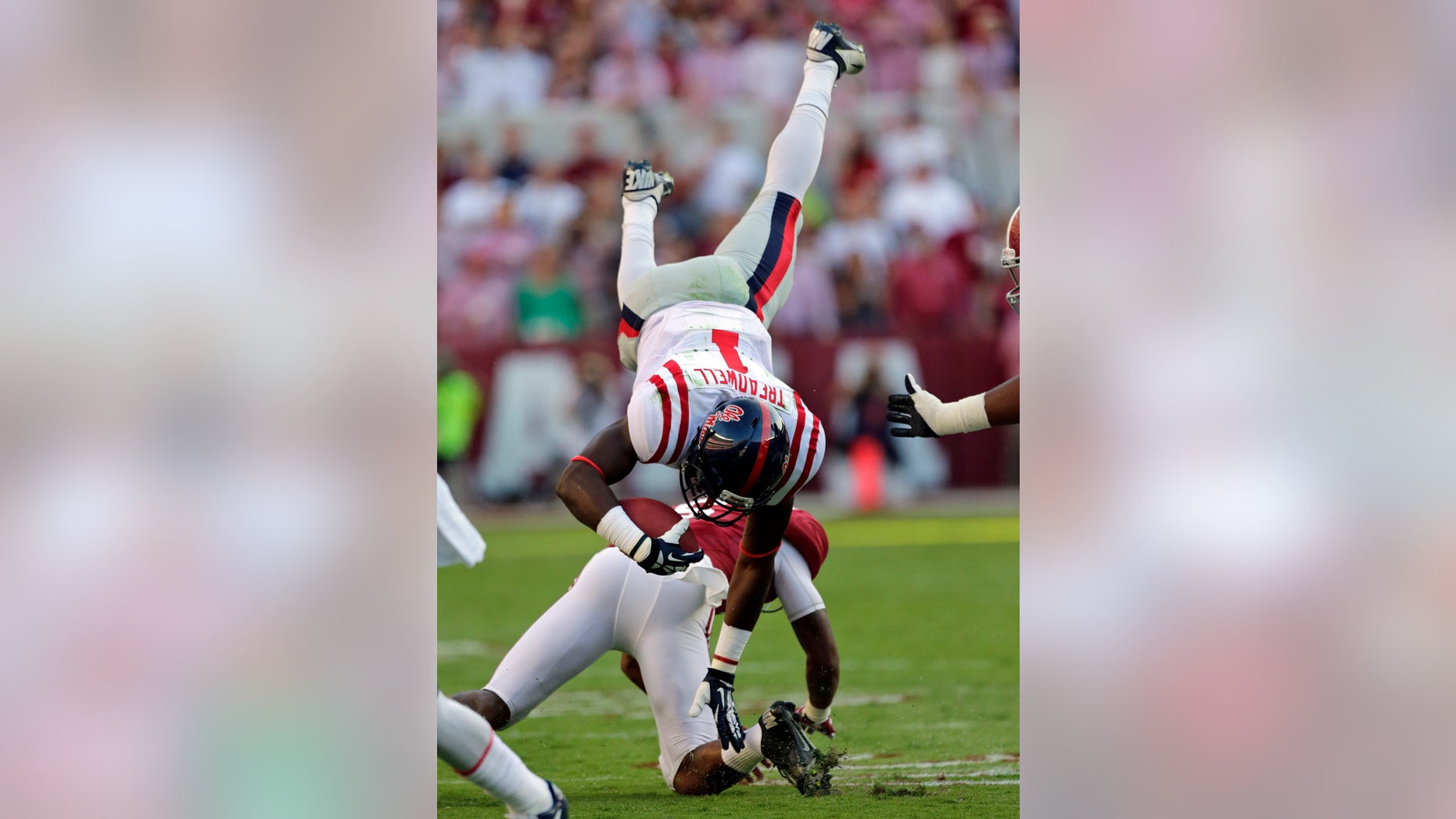Mississippi wide receiver Laquon Treadwell (1) is upended by Alabama defensive back Ha Ha Clinton-Dix (6) during the first half of an NCAA college football game in Tuscaloosa, Ala., Saturday, Sept. 28, 2013. (AP Photo/Dave Martin)