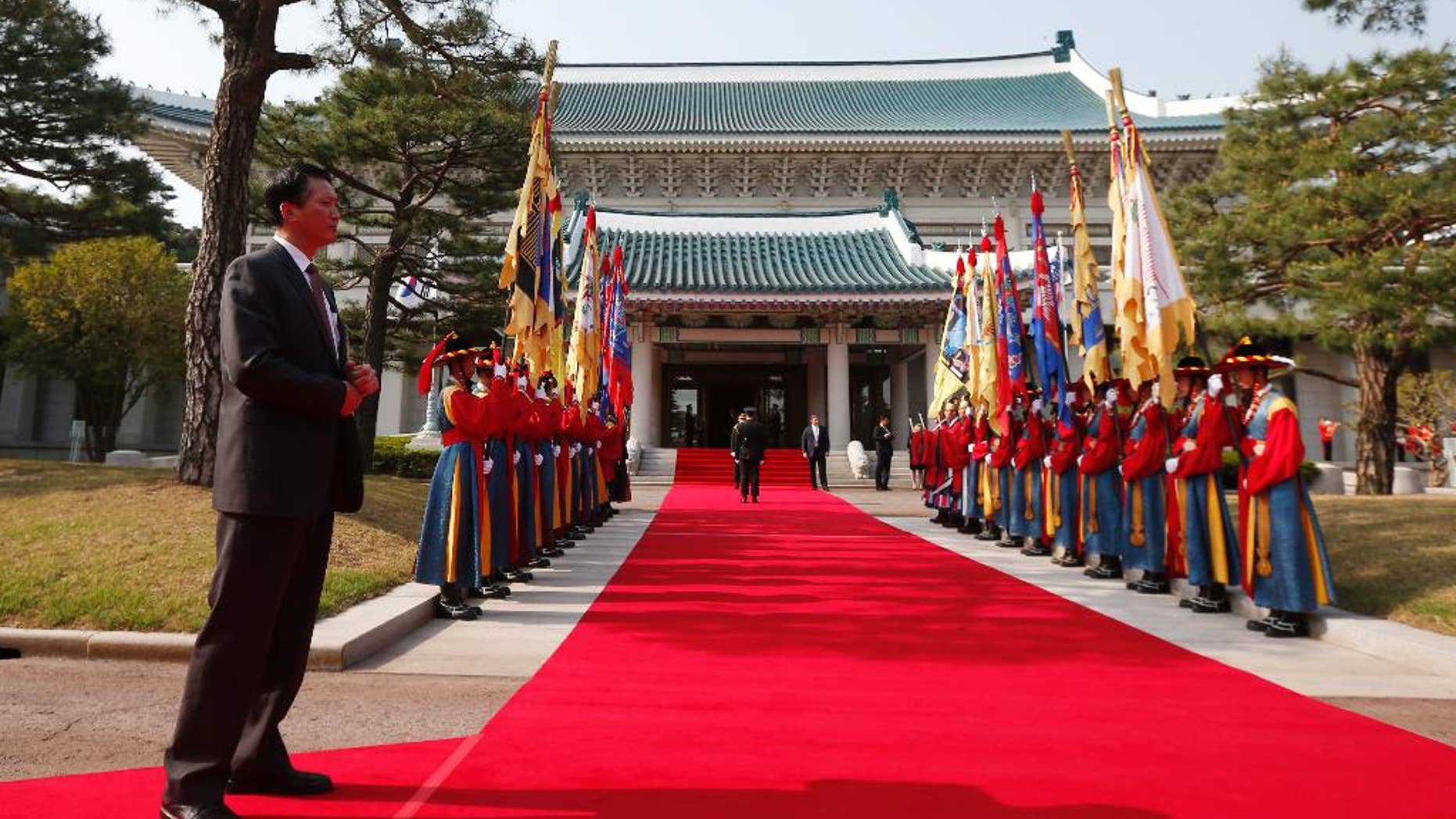 In this April 25, 2014, photo, a security official stands at the Blue House in Seoul, South Korea, before an official welcoming ceremony. South Korea said Wednesday, April 27, 2016, that North Korea has built a half-size mock-up of the South's presidential palace at a firing range in what looked like preparations for a live-fire drill. (AP Photo/Charles Dharapak)