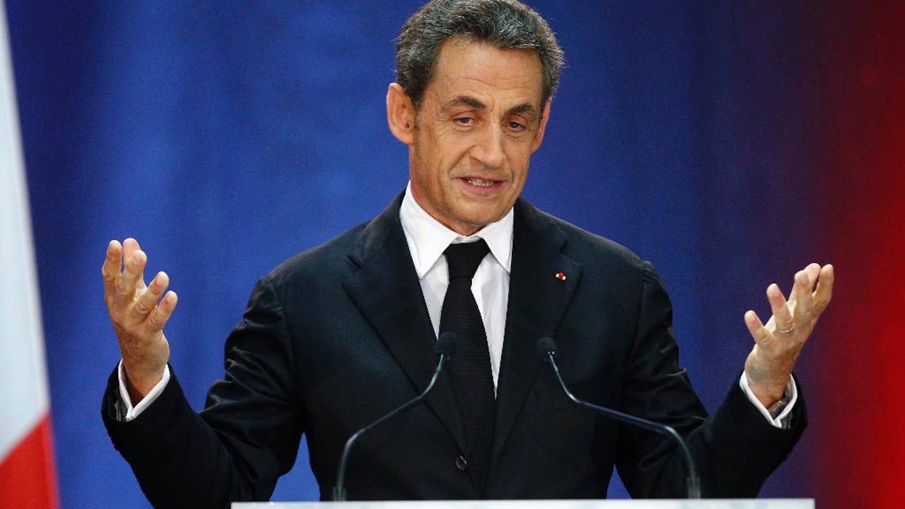 FILE- In this Thursday, Sept. 25, 2014 file photo, former French President, Nicolas Sarkozy, speaks as part of his campaign for the leadership of his conservative UMP party in Lambersart, northern France. Sarkozy has confirmed his intention of stepping down from being the head of the conservative party in order to run in presidential election primaries. (AP Photo/Michel Spingler, File)