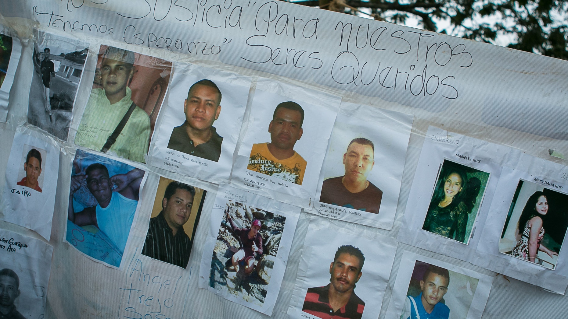 A banner with photos of several missing miners hangs on a tree near Tumeremo, Venezuela, March 8, 2016.