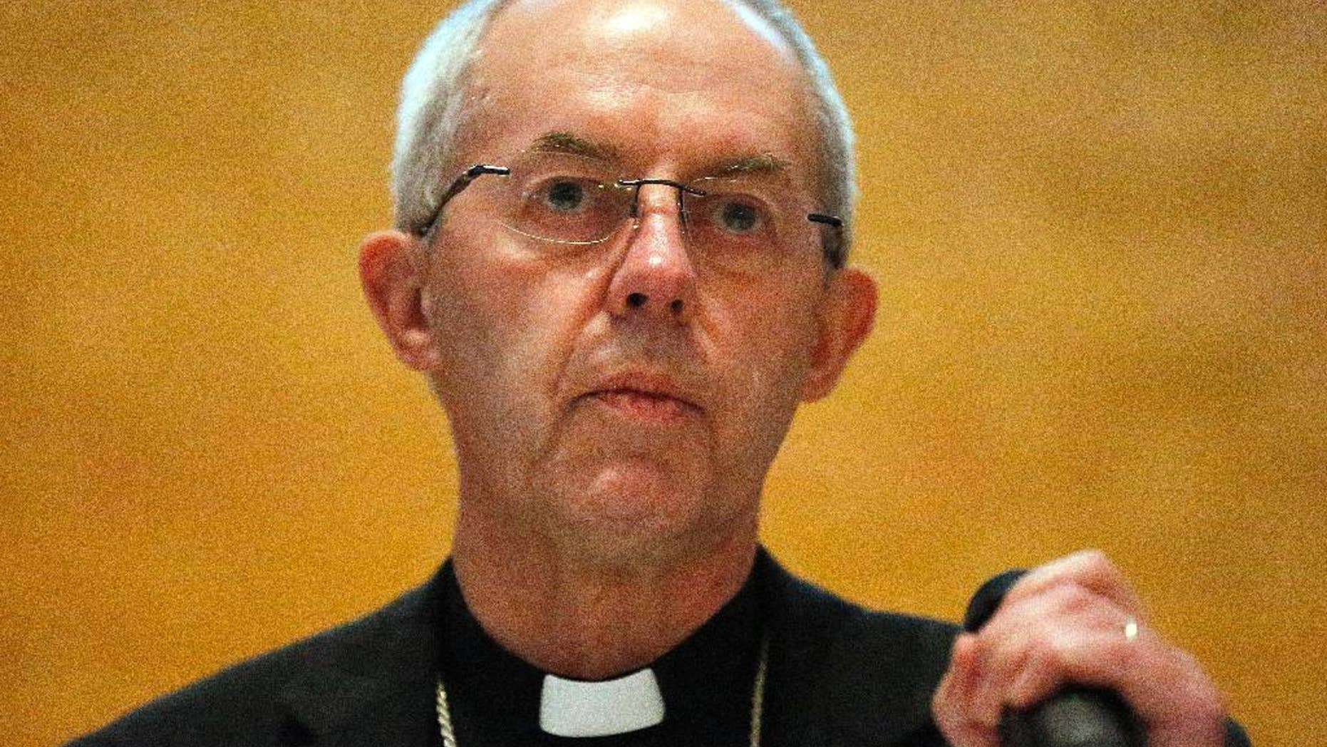 FILE- In this Friday, Jan. 15, 2016 file photo, the Archbishop of Canterbury, Justin Welby, addresses the media during a press conference in Canterbury, England. The archbishop of Canterbury said, Saturday, April 9, 2016, DNA tests have identified his real father, but the revelation hasn’t shaken his sense of identity. (AP Photo/Frank Augstein, File)
