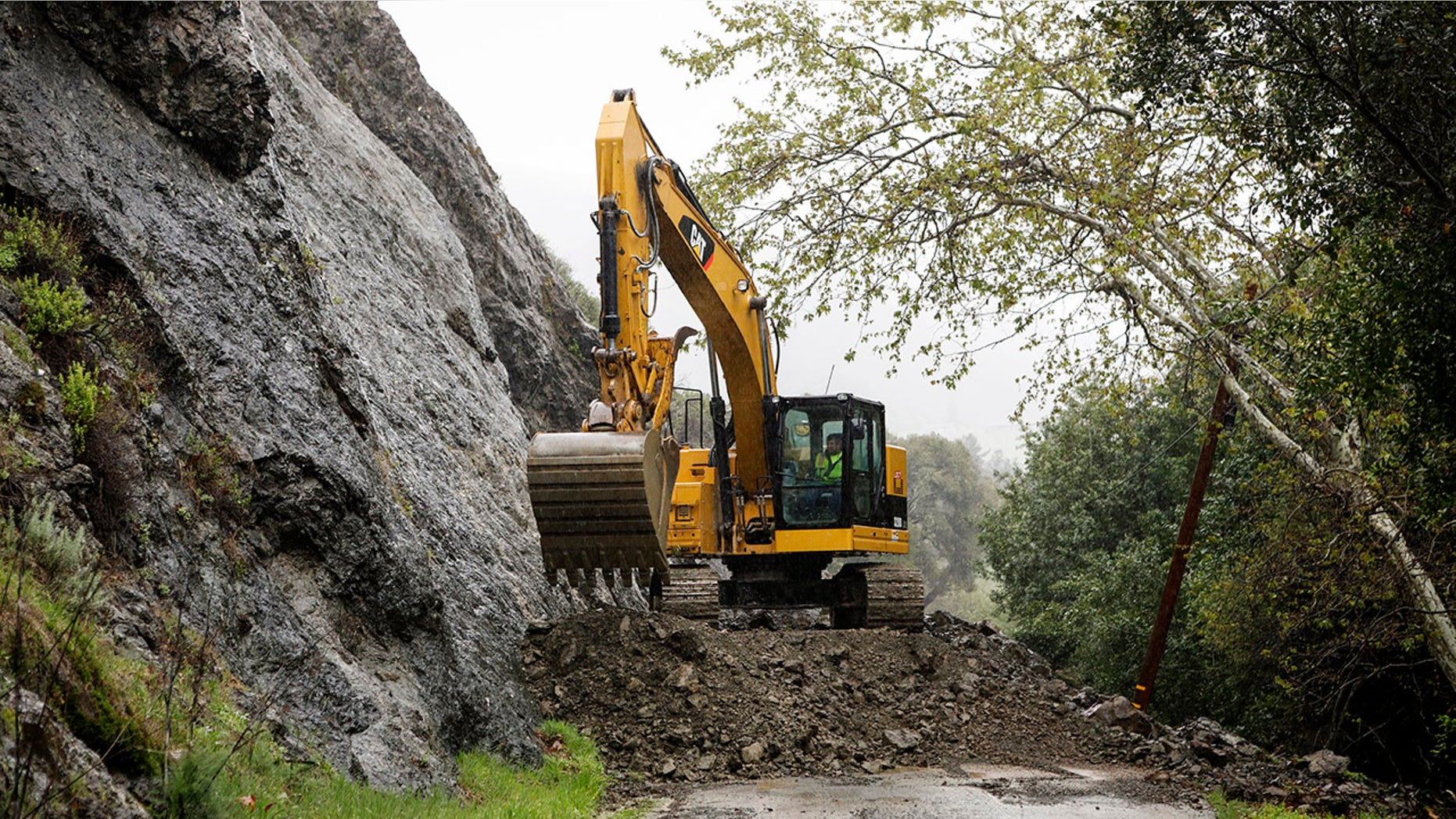 A crew works to clear Santa Rosa Creek Road after a rockslide in Cambria, Callif. Crews worked Wednesday, March 21, 2018, to clean up the rockslide.
