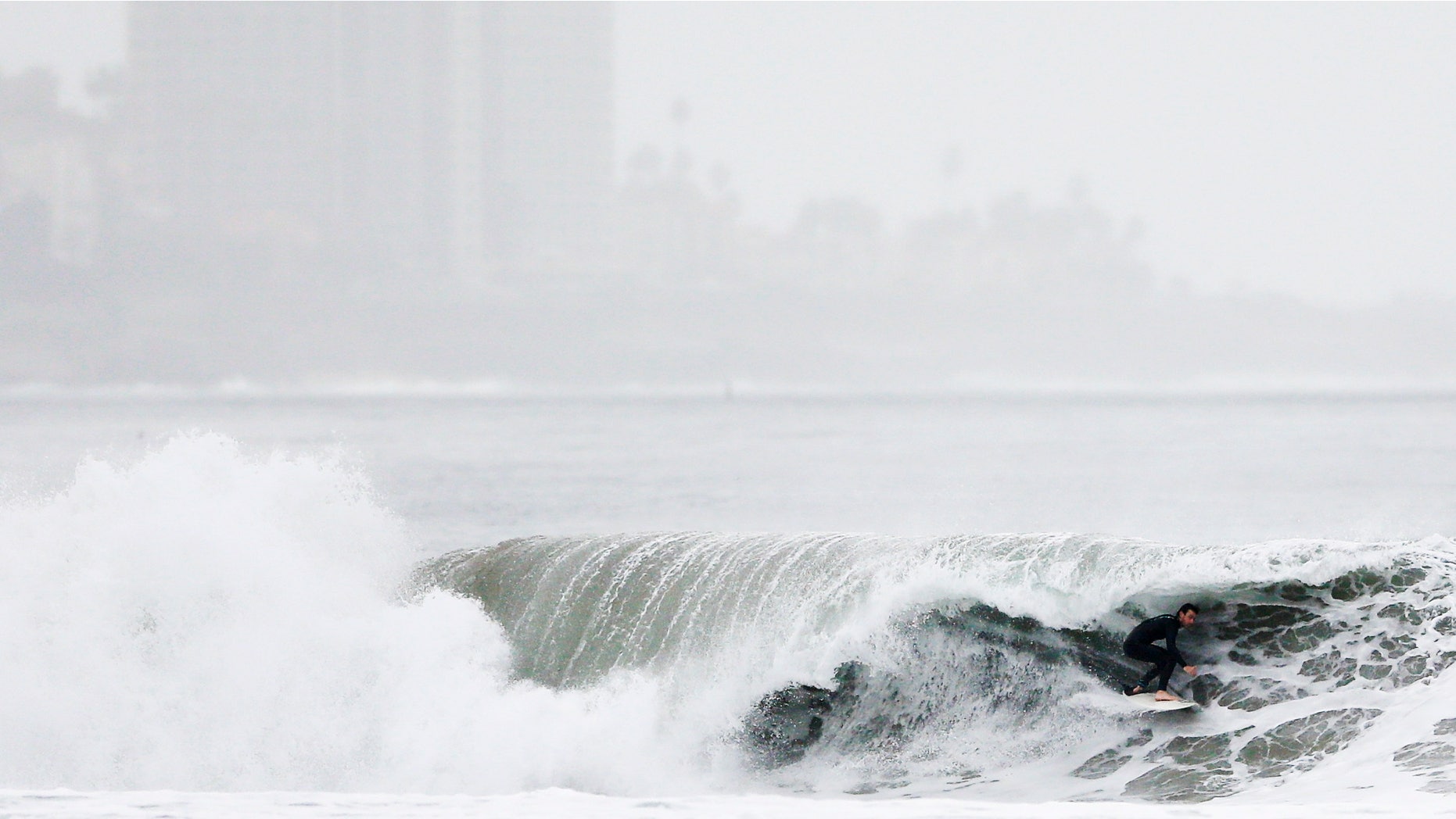 Dec. 16, 2014: A surfer rides a wave at Blacks Beach