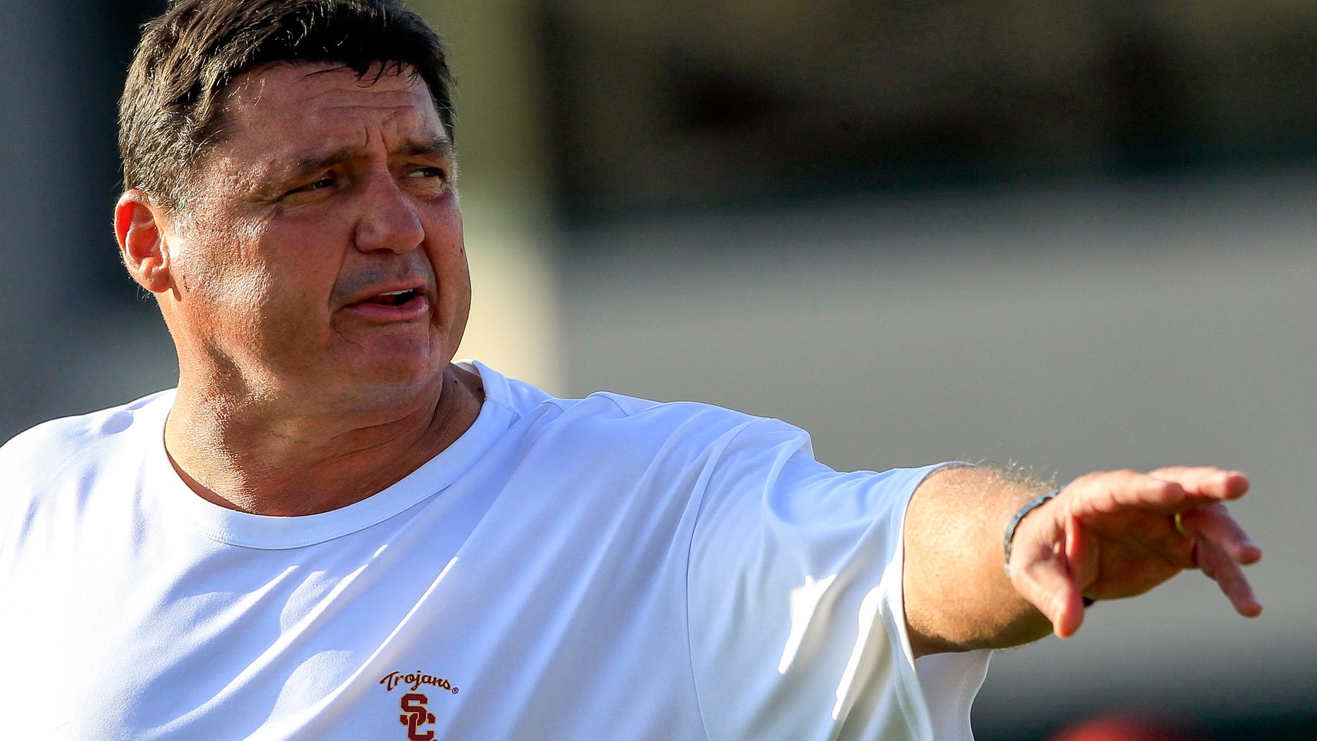 FILE- In this Oct. 2, 2013, file photo, Southern California's interim football coach Ed Orgeron guides his players during NCAA college football practice in Lo Angeles. The former Ole Miss coach welcomes the opportunity of his interim job, and the Trojans say he's injecting energy back into a weary team. (AP Photo/Damian Dovarganes, File)