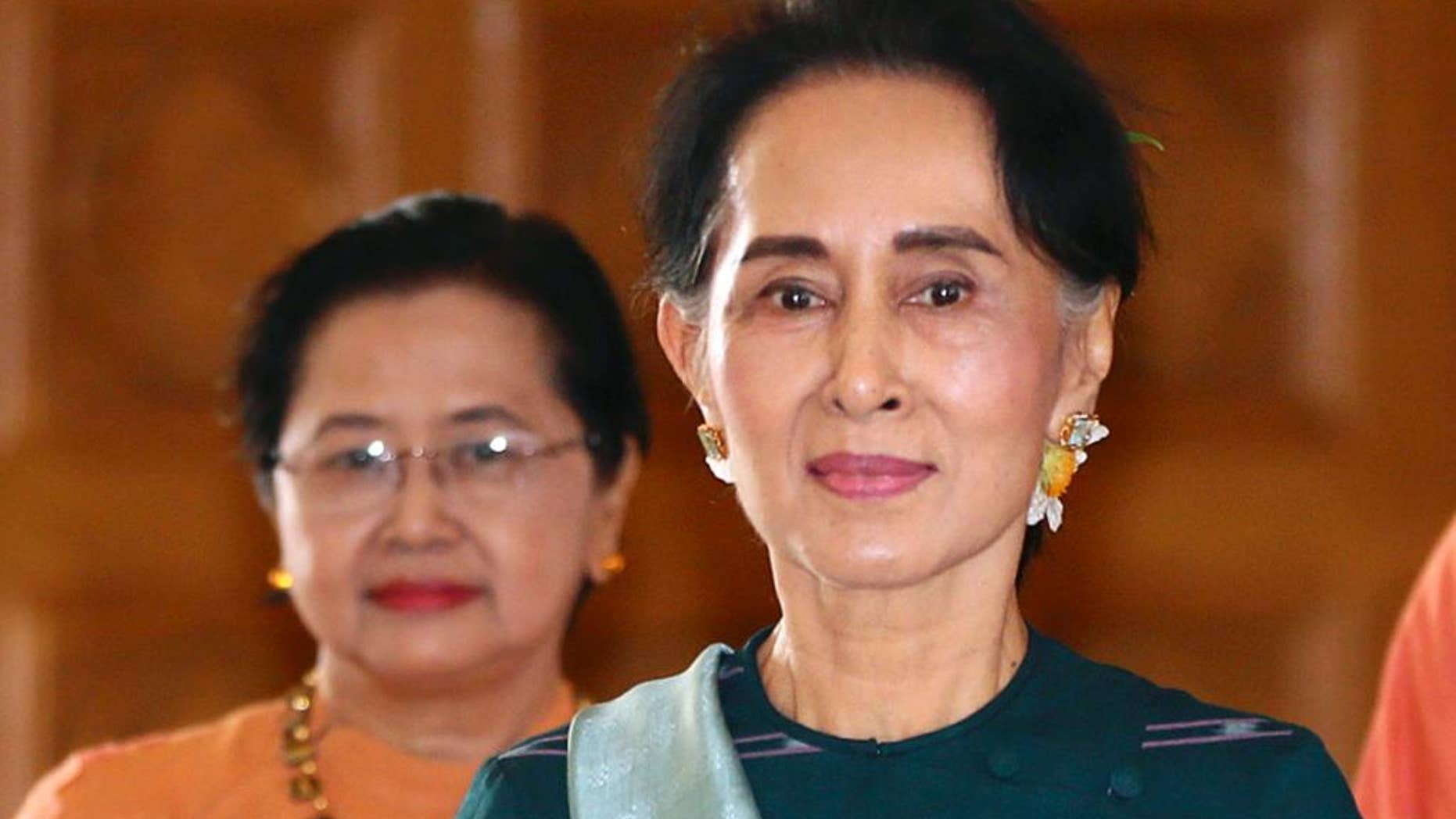 FILE - In this March 15, 2016 file photo, National League for Democracy party (NLD) leader Aung San Suu Kyi arrives at Myanmar's parliament in Naypyitaw, Myanmar. Amnesty International urged Aung San Suu Kyi and her party's new government to release all political prisoners when they take office next week, saying Thursday that Myanmar's historic transition is an opportunity to break away from the repression of the former junta rule. (AP Photo/Gemunu Amarasinghe, File)